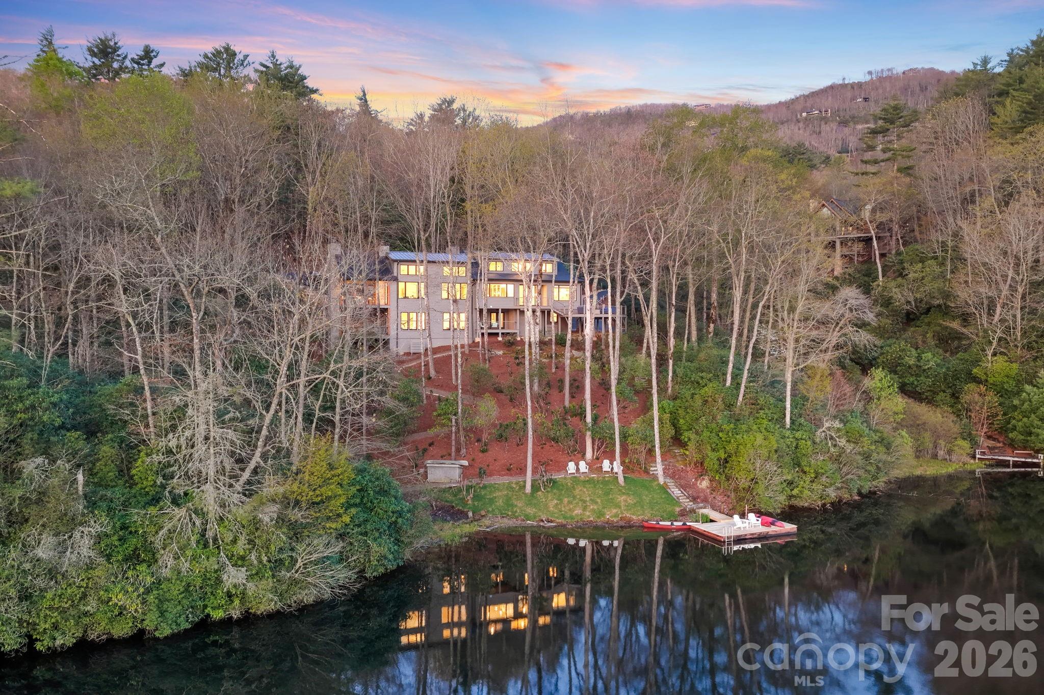 Presenting the most exquisite turnkey modern mountain home, fully renovated and newly constructed! Perfectly located on the highly desired but rarely available Lake Cardinal within the exclusive Lake Toxaway Estates, just minutes from the Lake Toxaway Country Club, Golf Course, marina, and the Greystone Inn! Curated by a top-notch design build team, quality and attention to detail are evident throughout this stunning home! The 1st floor features a graceful double door entry with views straight through to the lake. The open floorplan includes walls of windows with unobstructed water views, an incredible Great Rm with 16'+ vaulted ceilings, stone fireplace, beamed ceiling, and access to the large, covered deck with fireplace and outdoor grilling station! The chef's Kitchen will delight with Quartz counters, Thermador appliances, and oversized island. Gather in front of the cozy Hearth Rm fireplace and still be part of all the activity. The luxurious Owners Suite offers utopian lake views, a Sitting area, custom spa Bath, and walk-in Closet! Access to the 2 car Garage, Pantry / Laundry Center, firepit Deck, and 1/2 Bath complete the main level. Upstairs you will find 2 Ensuite Bed Rms, each with gorgeous Baths, along with a Loft area, perfect for reading or an Office, all with exceptional Lake Cardinal views! Downstairs is a huge Family Rm with Bar, and access to 2 other Decks. There is a perfect Flex space or Den with full Bath, a lower level Kitchen with outdoor access, and 1/2 Bath. Another 2-car tandem Garage (4 car total) and lots of storage space round out the Lower Level. The site boasts over 150' of waterfront access through the landscaped paths to the dock. Nestled on 1.8 acres, the 65 acre Lake Cardinal offers the most spectacular lakefront experience, with just a few homes, where you will enjoy peace and tranquility. Take advantage of the Lake Toxaway Marine Yacht Club to enjoy easy boating without the expense or maintenance of owning your own!  Updates include new mechanicals, roof, windows, appliances, cabinetry, trim, decks, lighting and flooring. Home can be purchased complete with all new designer furnishings.  Membership to Lake Toxaway Country Club through application and availability.