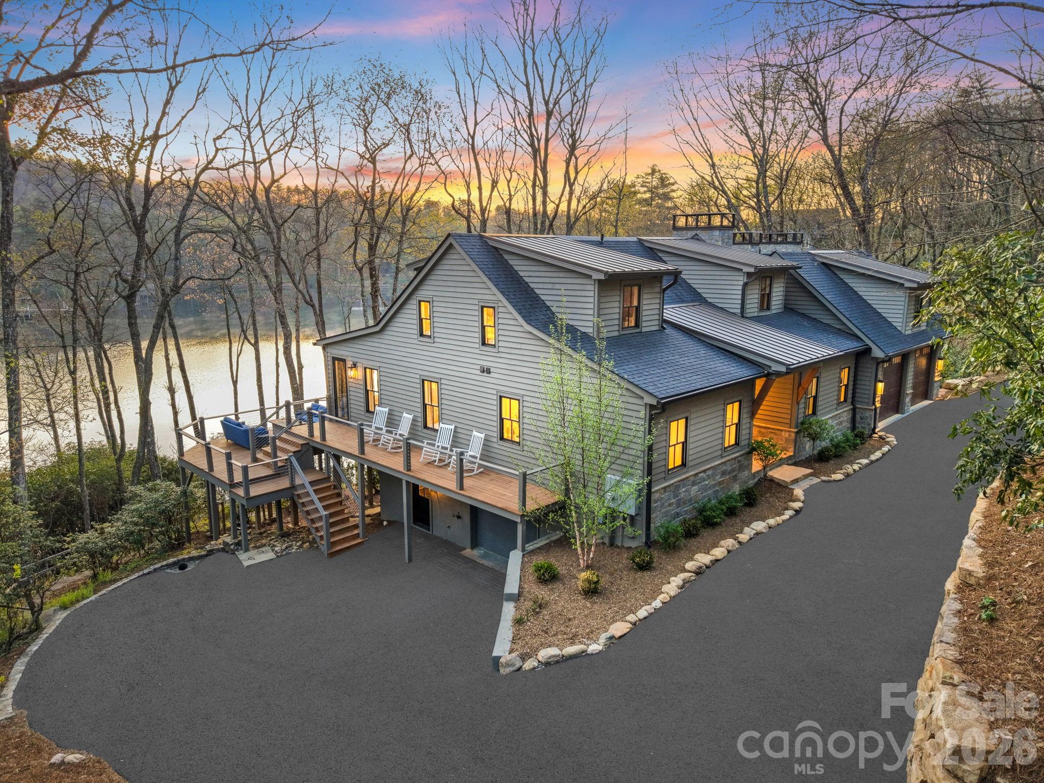 Presenting the most exquisite turnkey modern mountain home, fully renovated and newly constructed! Perfectly located on the highly desired but rarely available Lake Cardinal within the exclusive Lake Toxaway Estates, just minutes from the Lake Toxaway Country Club, Golf Course, marina, and the Greystone Inn! Curated by a top-notch design build team, quality and attention to detail are evident throughout this stunning home! The 1st floor features a graceful double door entry with views straight through to the lake. The open floorplan includes walls of windows with unobstructed water views, an incredible Great Rm with 16'+ vaulted ceilings, stone fireplace, beamed ceiling, and access to the large, covered deck with fireplace and outdoor grilling station! The chef's Kitchen will delight with Quartz counters, Thermador appliances, and oversized island. Gather in front of the cozy Hearth Rm fireplace and still be part of all the activity. The luxurious Owners Suite offers utopian lake views, a Sitting area, custom spa Bath, and walk-in Closet! Access to the 2 car Garage, Pantry / Laundry Center, firepit Deck, and 1/2 Bath complete the main level. Upstairs you will find 2 Ensuite Bed Rms, each with gorgeous Baths, along with a Loft area, perfect for reading or an Office, all with exceptional Lake Cardinal views! Downstairs is a huge Family Rm with Bar, and access to 2 other Decks. There is a perfect Flex space or Den with full Bath, a lower level Kitchen with outdoor access, and 1/2 Bath. Another 2-car tandem Garage (4 car total) and lots of storage space round out the Lower Level. The site boasts over 150' of waterfront access through the landscaped paths to the dock. Nestled on 1.8 acres, the 65 acre Lake Cardinal offers the most spectacular lakefront experience, with just a few homes, where you will enjoy peace and tranquility. Take advantage of the Lake Toxaway Marine Yacht Club to enjoy easy boating without the expense or maintenance of owning your own!  Updates include new mechanicals, roof, windows, appliances, cabinetry, trim, decks, lighting and flooring. Home can be purchased complete with all new designer furnishings. Adjacent 2.5 acre building site complete with 4 Bed Rm approved septic and lake access also available.  Membership to Lake Toxaway Country Club through application and availability.