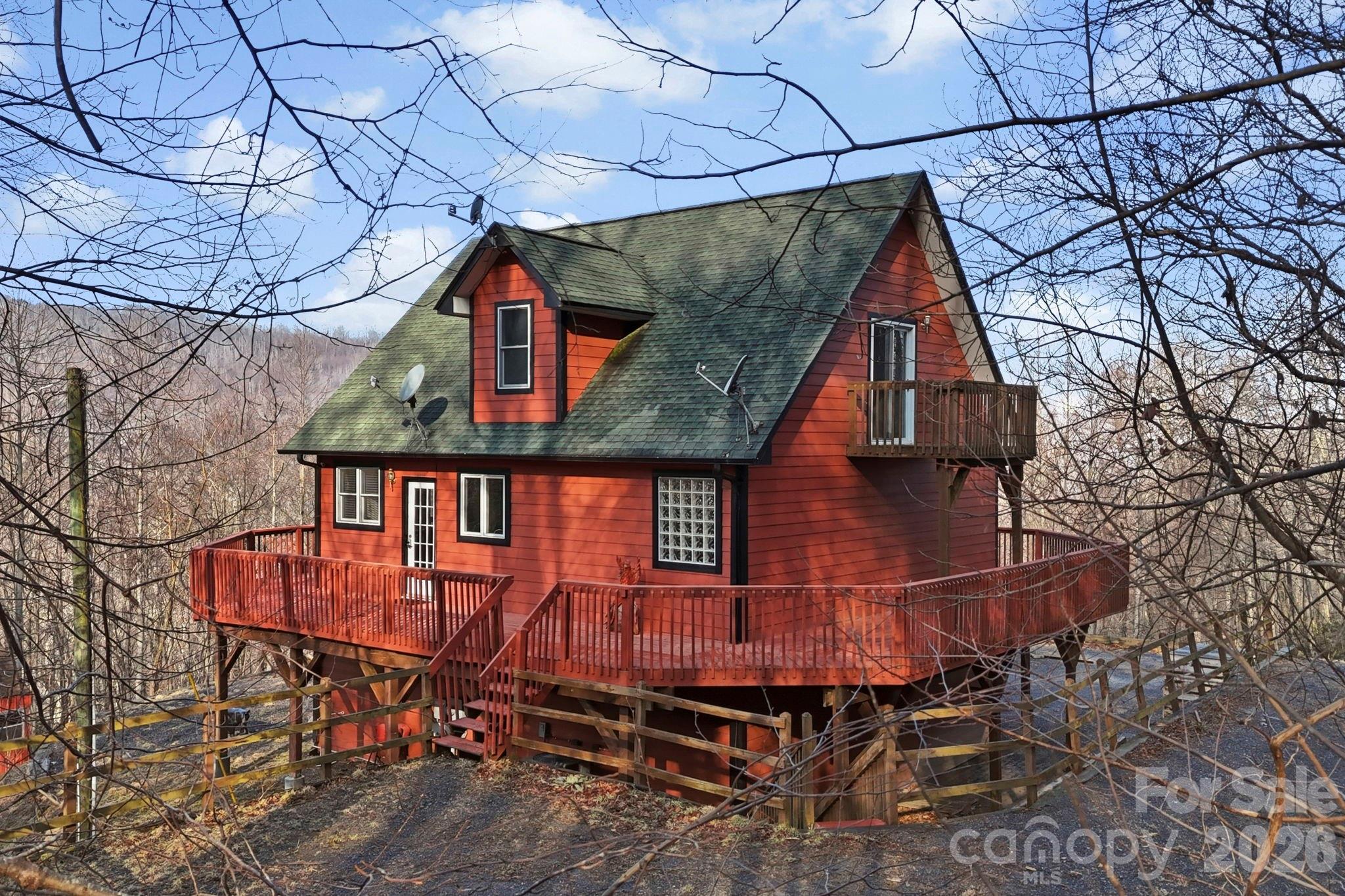 Nestled in the quiet mountains of Swannanoa, this 3BR/3.5BA home on 2.68 acres offers the perfect blend of privacy, comfort, and convenience—just a short drive to both Asheville and Black Mountain. Step inside and imagine entertaining around the spacious kitchen island while taking in stunning long-range mountain views. The expansive wraparound porch invites you to relax, unwind, and soak in the peaceful surroundings.

The main level offers comfortable everyday living, while the finished basement provides incredible flexibility with a huge flex space, full bathroom, and walk-out patio featuring a hot tub—perfect for guests, hobbies, or additional living space. A one-car garage with laundry adds extra convenience.

Whether you're enjoying quiet mountain mornings, hosting friends and family, or simply taking in the bold mountain views, this serene retreat offers the mountain lifestyle you've been looking for. AWD Recommended.