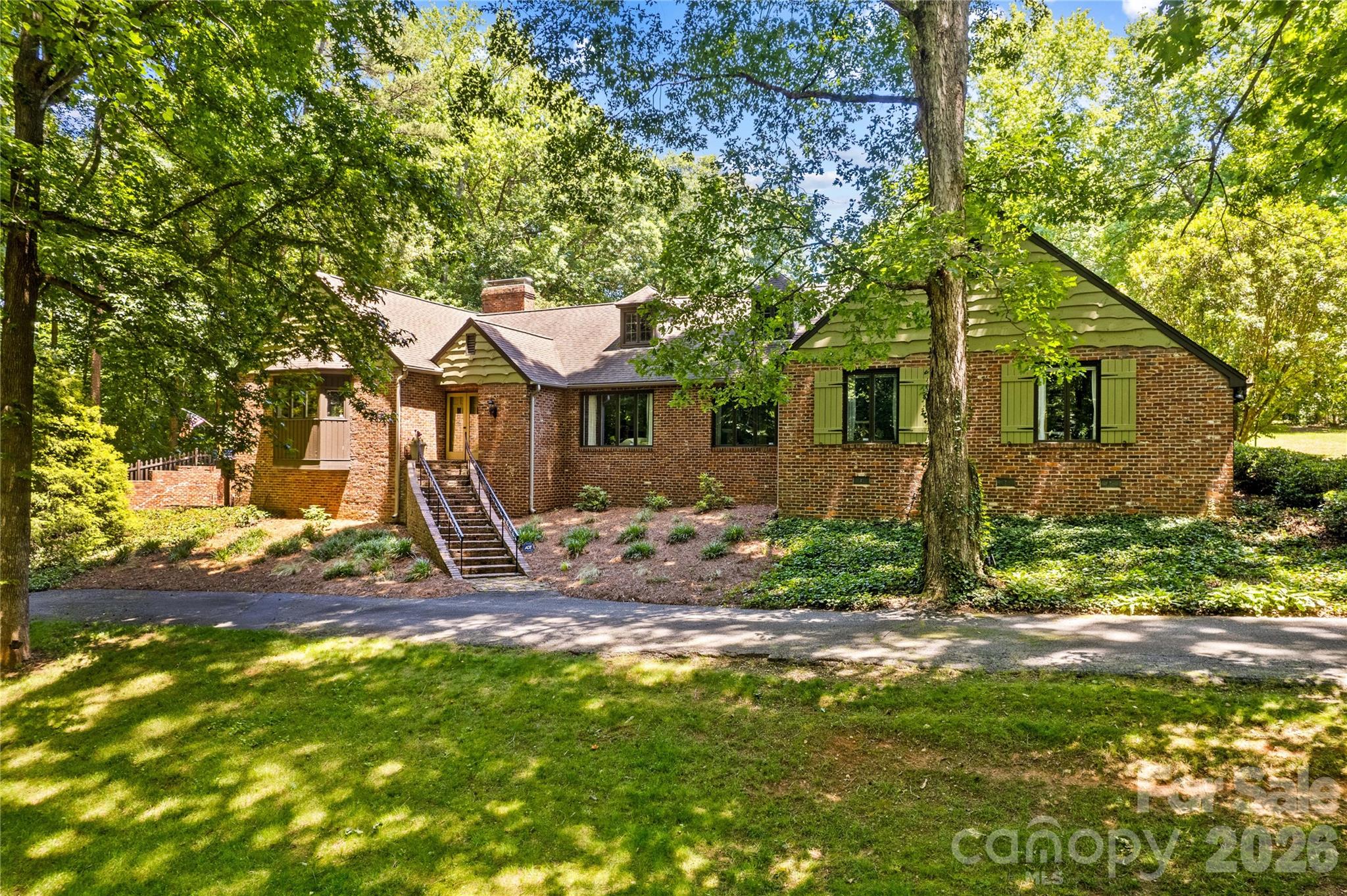 Looking for a truly unique, cozy, and custom-built retreat in an exceptionally private setting? Look no further—this one-of-a-kind property offers the perfect blend of charm, character, and tranquility.
 This stunning 3,900-square-foot home features four bedrooms, two full baths, and two half baths, with distinctive architectural details throughout. The sunroom is filled with natural light and overlooks the peaceful, private side yard, creating the perfect space to relax year-round.
 The spacious English Country kitchen is designed for both everyday living and entertaining, showcasing two-tone cabinetry, quartz countertop, a large granite island with oversized breakfast bar offering abundant seating and lower cabinet storage.  A vaulted ceiling accented by impressive, exposed beams from an old schoolhouse.  In the great room the oversized fireplace with a German schmear finish creates a warm and inviting focal point, surrounded by built in bookcases adding to the home's unmistakable character.
 The formal dining room is rich with character, featuring beautiful heart of pine plank flooring and exposed ceiling beams that create a warm, inviting atmosphere. Just beyond, the sunroom features beautiful brick flooring, abundant windows, and a gas fireplace, making it a cozy retreat in every season or step outside to enjoy the private patio.
 Wide reclaimed heart of pine plank flooring extends throughout the kitchen, great room, hall, and dining room, enhancing the home's timeless appeal. 
 The primary suite offers its own private screened porch—the ideal place to enjoy your morning fix while listening to the sounds of nature. The primary bath offers dual vanity/dressing areas, a soaking tub and separate shower.  The two front bedrooms are good sized with a smaller bedroom near the half bath.  Just off the front entry, you'll find a versatile flex room that can easily adapt to your lifestyle. Whether you envision it as a home office, home schooling,  music room, playroom, sewing or craft room, library, or quiet sitting area, this flexible space offers endless possibilities—limited only by your imagination.  
 The well-appointed laundry room includes cabinetry, a utility sink, and overhead storage racks.
 The partially finished basement provides exceptional flexibility with a cozy private studio that can serve as a home office, fitness room, music room, or hobby space and has a half bath. A 2 car garage. mechanical area, and additional unfinished basement storage completes the lower level.  In addition to the attached two-car garage with basement access, the property features a detached two-bay garage equipped with utilities, including RV power hookup capability on the rear lot #12.
 Situated on 1.656 private acres this remarkable property also includes additional four separately subdivided lots on Chantilly Lane adding 1.53 acres which offers future possibilities for investment or expansion.  Equaling a total of 4.156 acres.  These lots will require septic and connection to county water system  if developed.
 If you're seeking privacy, peaceful surroundings, and the feeling of country living while remaining within the Statesville city limits, this exceptional property delivers. Conveniently located just minutes from I-40, I-77, shopping, dining, and everyday amenities, this is a rare opportunity to own a home unlike any other.