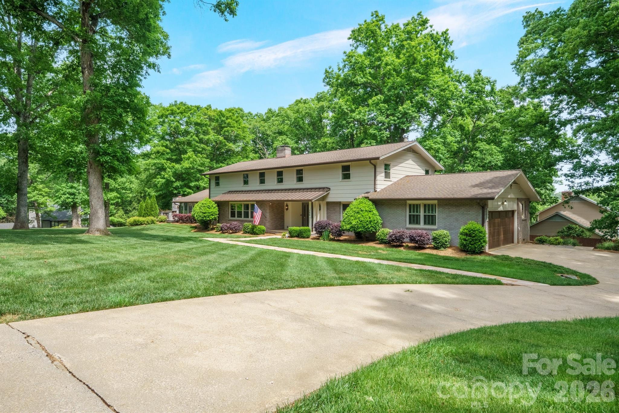 Exceptional opportunity to own a beautifully updated estate on 1.07 acres in a highly sought-after NW Hickory location. With over 6,000 heated square feet, this move-in ready home offers the rare combination of space, privacy, and refined upgrades—properties like this do not come along often! This expansive 1.5-story home with a mostly finished lower level features 5 bedrooms, 4 full bathrooms, and 3 half bathrooms, along with 2 double garages for a total of four garage spaces. From the moment you enter, the grand foyer with a sweeping curved staircase creates an immediate sense of elegance and scale. Designed for both entertaining and everyday comfort, the home offers formal living and dining rooms, along with a warm, inviting den featuring a gas log fireplace and custom built-ins. The updated kitchen is complete with granite countertops, lots of cabinetry, newer appliances, breakfast bar, and hardwood flooring, all opening to a light-filled breakfast area with a dramatic curved window. A spacious butler’s pantry/oversized laundry room w/sink add both function and convenience, while a large main-level flex space provides the perfect option for a home office, playroom, or additional living area. The sunroom is equipped with its own mini-split system& flows effortlessly onto an expansive patio with a beautiful outdoor fireplace—ideal for hosting or relaxing year-round. Upstairs, the generous layout continues with 5 bedrooms and 4 full bathrooms, including a luxurious primary suite featuring hardwood floors, three closets, and a beautifully updated spa-like bathroom with dual sink vanity, custom cabinetry, tiled flooring, and a walk-in tile/glass shower. The fully finished lower level offers incredible versatility with cool terazzo floors, a large recreation room with fireplace(wdstove has been removed--sellers have never used...unsure if functional), kitchenette/wet bar with new countertops, workout room, half bath, and abundant storage space. A second double garage adds even more flexibility for vehicles, hobbies, or storage. With a circular driveway AND a back driveway, brick patio, mature setting, and extensive indoor and outdoor living space, this home delivers a lifestyle that is increasingly hard to find in today’s market. Schedule your private showing today—homes of this size, condition, and location are in high demand and do not stay available for long!