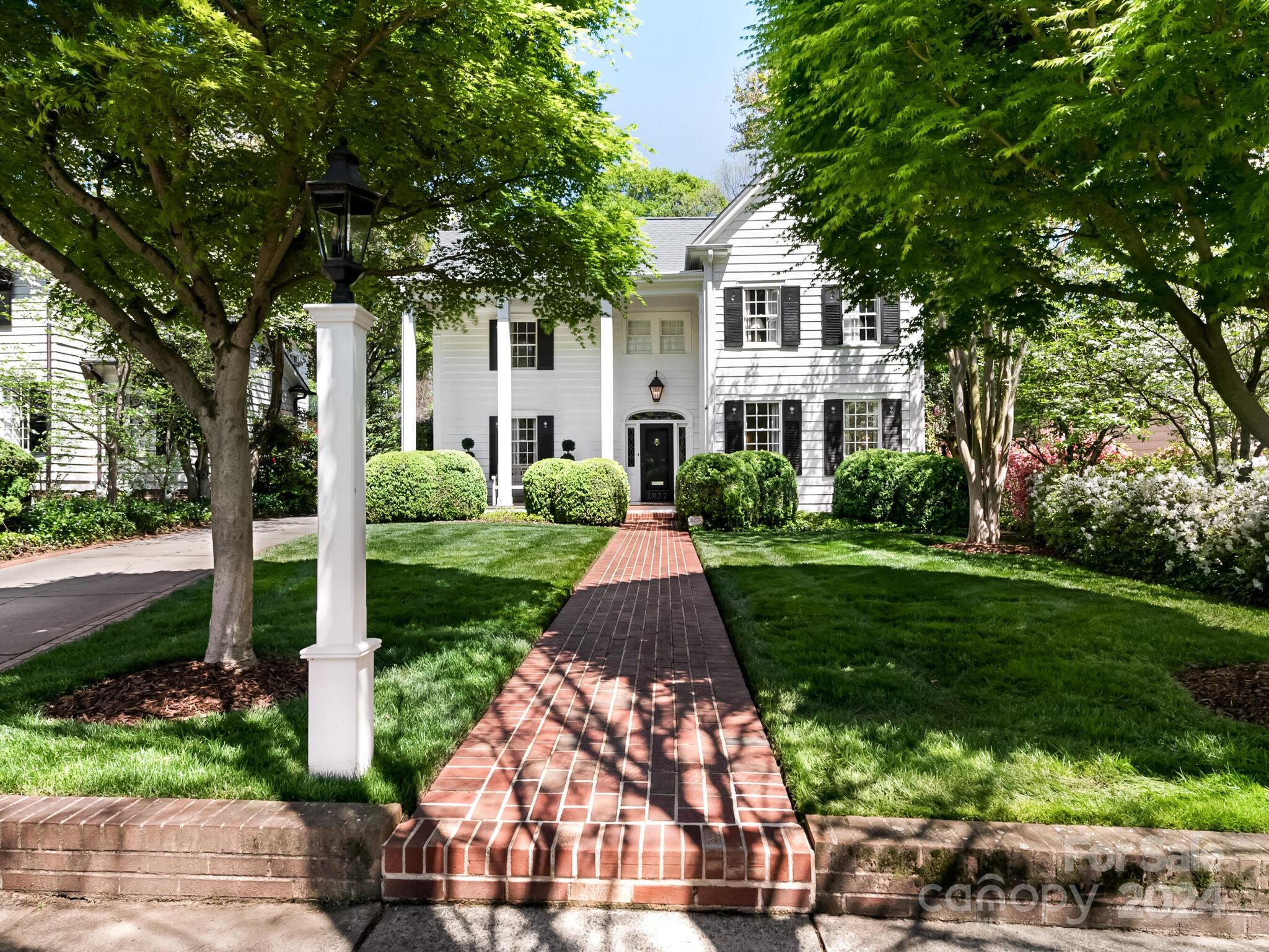 Classic Myers Park home features a top-to-bottom renovation and exudes luxury and charm! Gorgeous hardwoods on both floors and 9 ft’ ceilings on the main level. Designer fixtures and finishes throughout. Covered rocking-chair front porch opens to the elegant formals and the spacious family room and rear mud room are perfect for everyday living. Chef’s kitchen features marble countertops, butcher-block island, high-end stainless appliances (including Wolf gas range) and walk-in pantry, plus breakfast room with built-in dining banquet. Expansive Primary Suite with 2 walk-in closets and stunning marble bath with soaking tub and oversized walk-in shower. Laundry room upstairs. Covered back porch with brick fireplace plus patio. Detached 2-car garage with incredible apartment above offers 5th bedroom and full bath!  Full house generator and new water heater. Too many custom features to list- meticulously maintained and in pristine move-in ready condition!