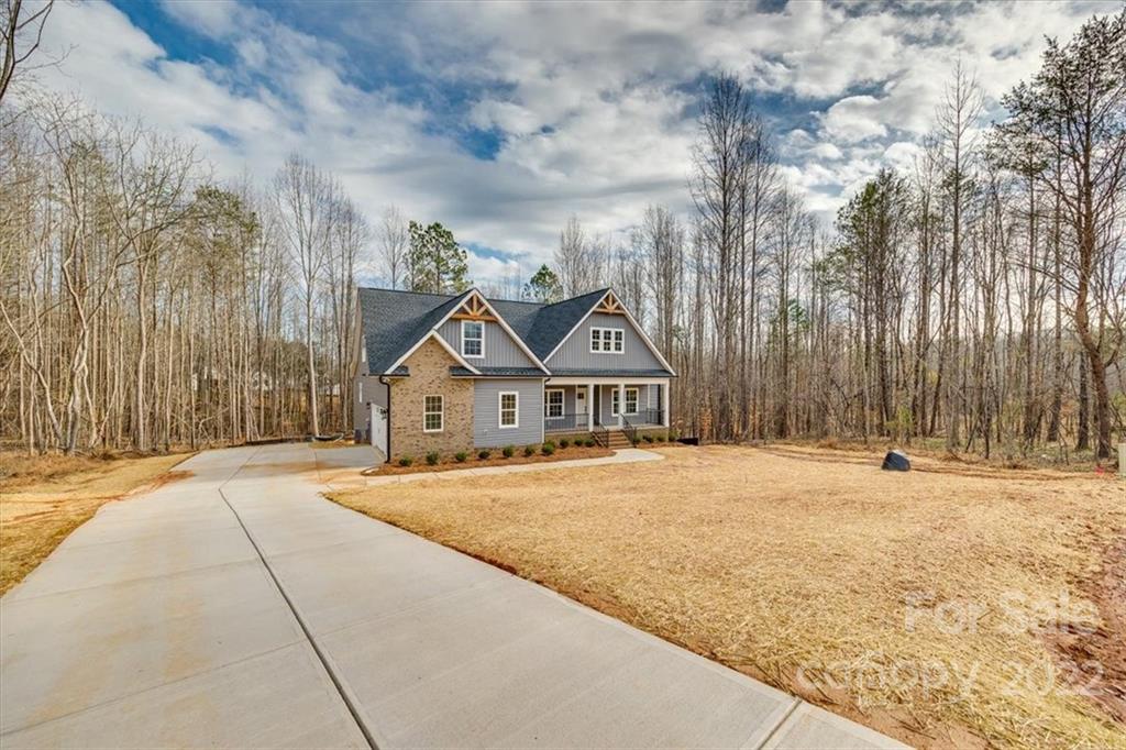 Quality construction by a reputable and seasoned builder, Homes by Christopher! Welcome to 8045 Smooth Stone Ct. Clover, SC offering 1.21 acres in private cul-de-sac. Built in the desired Sanders Landing neighborhood and located in the top ranked Clover School district, this home is dressed to the nines with high-end finishes. (See spec sheet in associated docs) Enjoy the primary on the main, an open floor plan with fireplace and coffered ceiling, and a screened porch that offers a wooded view. This spectacular home has luxury vinyl plank, a variety of ceilings, a tankless water heater and quartz c-tops. Upstairs offers a bedroom with full bath and spacious media room. Call for private showing!