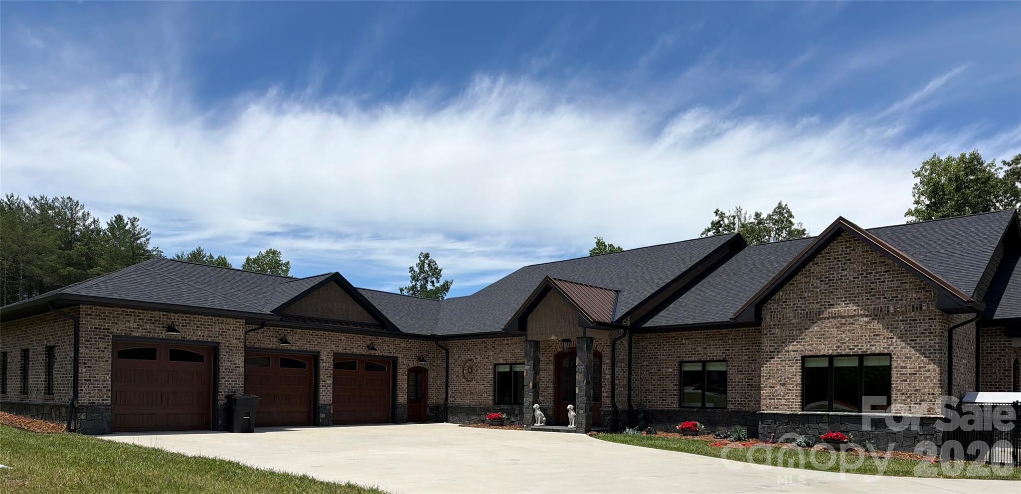 Experience ultimate luxury in this custom-built ranch home located within the gated community of The Peninsula at Lake James. From the moment you enter through the double French doors, you are greeted by breathtaking, expansive lake views that frame the home from nearly every window. Situated on a rare, nearly one-acre level waterfront lot, this property offers unparalleled access and comfort.

The thoughtful split-bedroom floor plan ensures privacy, featuring two expansive primary suites on opposite sides of the home, each boasting luxurious ensuite bathrooms complete with soaker tubs and one has a steam shower. A third bedroom offers generous space with adjacent full bathroom access. The heart of the home is the welcoming great room, anchored by a gourmet kitchen featuring a massive island and an airy dining area perfect for entertaining. Beyond the main living areas, the home offers several versatile bonus spaces ideal for a home office, gym, or potential additional bedrooms.

Outdoor living is equally impressive with a fully fenced backyard featuring durable aluminum fencing and convenient double-gate access on all sides. A covered deck and patio space allows for grilling and social time. Enjoy easy access to the community pool or relax in your private, conveying jacuzzi/hot tub. For the car or boating enthusiast, the massive 1,000+ sq. ft. tandem garage provides ample space for four vehicles or safe winter boat storage. Additional peace of mind is provided by the included backup whole house generator. This remarkable waterfront home truly offers it all.

Key Property Features:
*   Waterfront Living: Rare, level, nearly one-acre lot with expansive views from every room.
*   Primary Suites: Two private primary bedrooms with luxury ensuite bathrooms (soaker tubs and steam shower).
*   Gourmet Kitchen: Large island with open-concept dining and living areas.
*   Versatile Spaces: Multiple bonus rooms for home office, exercise studio, or extra bedrooms.
*   Garage & Storage: 1,000+ sq. ft. tandem garage with capacity for four cars or boat storage.
*   Outdoor Amenities: Fully fenced yard, private hot tub, and community pool access.
*   Added Value: Whole-home generator conveys with the property.
*   Prime Location: Situated in the well known, gated community of the Peninsula at Lake James.