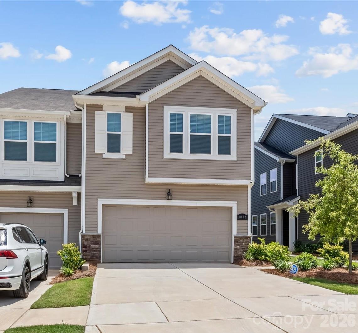 Step into this like-NEW two-story TH and experience a bright, welcoming space designed for both comfort and style. From the covered entry to the private patio and attached 2-car garage, every detail adds convenience and comfort. This end unit is filled with natural light from extra windows, highlighting the beautiful laminate wood flooring that extends throughout the main level for a seamless, modern look. At the heart of the home, the open-concept kitchen invites gathering and everyday living with its oversized island, quartz countertops, and stylish SS modern appliances. Flowing effortlessly into the family room and dining area, this space is ideal for entertaining or simply enjoying a quiet evening at home. Upstairs, the spacious primary suite offers a true retreat, featuring not one, but 2 custom walk-in closets. Enjoy a beautifully tiled shower along with the convenience of a private water closet. The double-bowl vanity provides generous storage and functionality, while two additional bedrooms and a versatile loft offer flexible space for guests, work, or play. A large upstairs laundry room adds even more practicality to this thoughtfully designed home. Enjoy outstanding community amenities including 2 community pools, clubhouses, and covered picnic area, perfect for gatherings with family and friends. Great location close to shopping, entertainment, and restaurants. Custom window shades, security system, refrigerator, and washer/dryer all remain with the home.