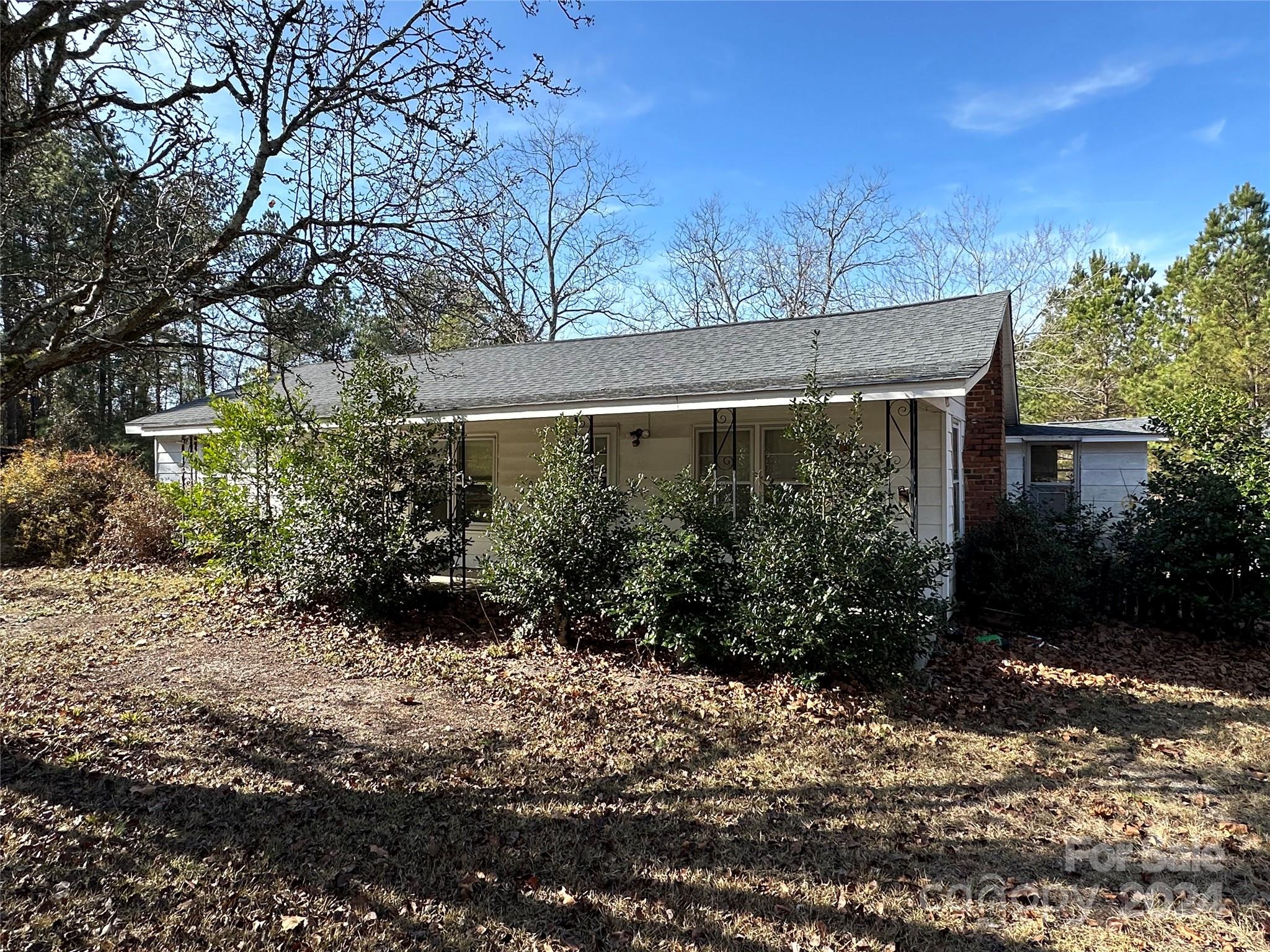 ACREAGE & Home!  6.7+- acres located outside Jefferson, SC, with an older home that is ready for updates. This property is easily accessible from Hwy. 265 and a short ride to Jefferson and Pageland.  The parcel has over 450 feet of frontage and most of the acreage lies behind the house, allowing for an ample yard and areas for a homestead.  The home is dated, but features a large living/dining area combination, a den, three bedrooms (one without a closet), two bathrooms, a kitchen and utility areas.  The yard has barns and sheds in various states of disrepair, that may be suitable for rehab.  Mature trees, including pecan trees, dot the rear and side yards.  Properties like this are getting harder to find.