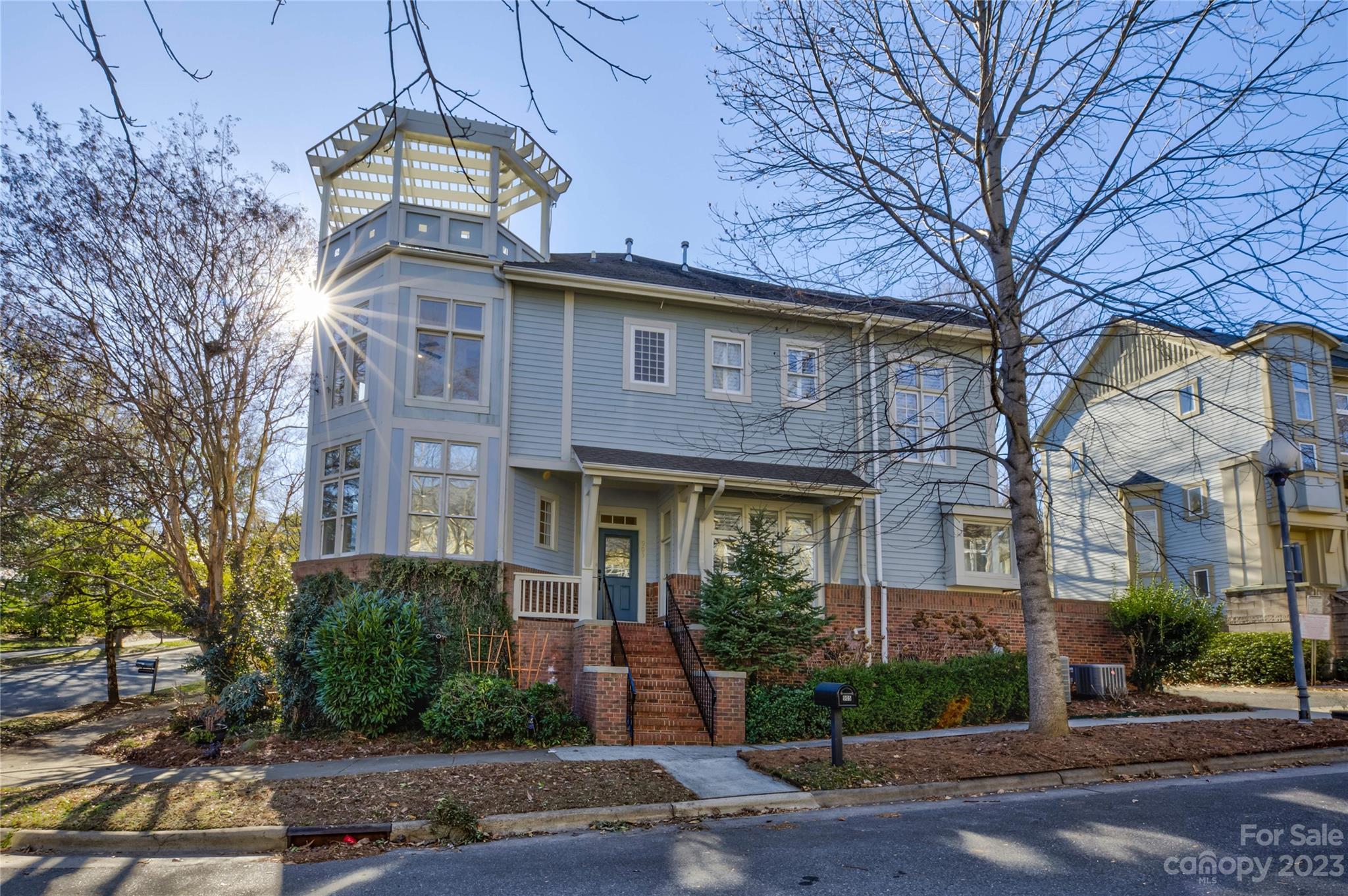 Rare find in the First Ward's Garden District! This townhome offers the best of both worlds - explore Charlotte and enjoy the comfort of home. The first floor features an open living space with high ceilings, crown molding, large  windows, and a gas fireplace. The KitchenAid-equipped kitchen has an island, eat in area, and easy access to the brick-enclosed patio and TWO-car garage. Three bedrooms, including a primary with two walk-in closets and ensuite tub and shower, are on the second floor. Don't overlook the large third-floor terrace - your personal escape awaits!