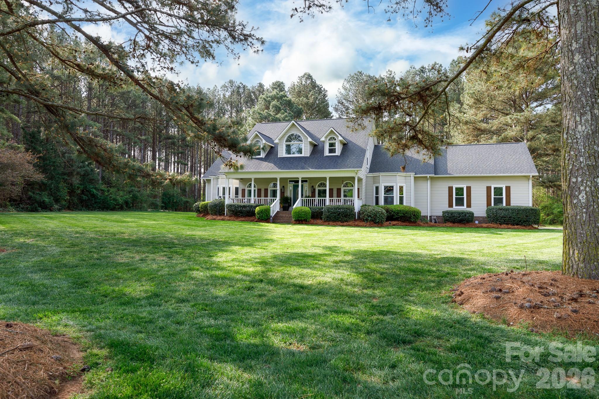 Country charm meets modern comfort in this stunning retreat on 3 acres in Campbells Crossing. From the moment you step onto the rocking chair front porch, you will feel the pace of life slow down. The interior is designed for both connection and privacy, featuring a formal dining room with an elegant tray ceiling featuring distinct wood beams. The heart of the home is a spacious kitchen, freshly painted Alabaster White with durable Persian Gold granite countertops, travertine backsplash, a wet bar, breakfast nook, and a reverse osmosis drinking faucet. The cozy living room is anchored by an electric fireplace and leads to the beautiful outdoors. With a primary suite and an additional bedroom on the main level, this layout offers incredible convenience. Upstairs, you will find plenty of room to grow with two more bedrooms, a bonus room, and a dedicated office space—plus a hidden gem of a playroom or study room attached to one of the bedrooms. The fenced backyard boasts a lush blend of rye and fescue grass, a firepit, and an oversized 34x26 patio, plus additional clearance beyond, offering the ultimate setup for summer gatherings or quiet mornings enjoying the serene views of your private 3-acre property. Additional features include a new roof (2025) gutter guards (2025), energy efficient windows, and a new driveway. Campbells Crossing is known for its iconic black wooden fencing, walking trails, and equestrian trails. It's truly country living at its finest.