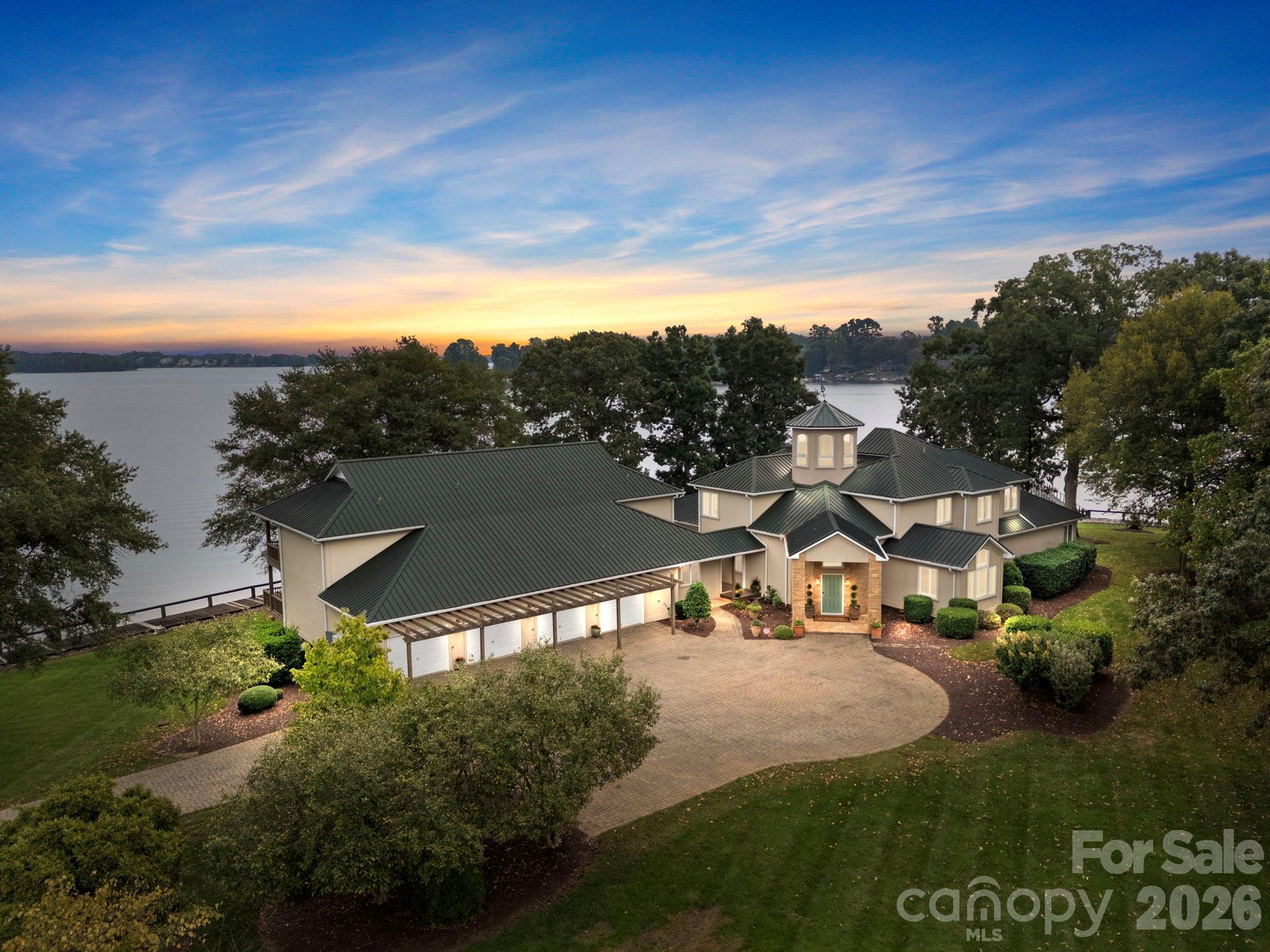 Welcome to 1890 Yacht Club Drive. Paradise Found! Have you been searching for that Lake Norman property with amazing unobstructed views, 1.48 acres with over 450 ft of shoreline?  Look no more! Resort style living at its best. This residence is simply the crown jewel of Lake Norman. Begin your mornings with sunrises over the lake and end your evenings with spectacular sunsets watching sailboats finding their way home. An icon on the lake, it is being offered for the first time. The compound includes the main home, three attached townhomes and a spacious 4 car garage.  The main home includes four bedrooms and 4 full bathrooms. The three townhomes include a total of seven additional bedrooms and four full baths and 2 half baths.  This distinctive property allows for both connection and privacy for friends and guests. Perfect setting for a corporate retreat or multigenerational living. The main home boasts stunning architecture where luxury and high function comfortably blend seamlessly. Highlights include an open modern floorplan with two-story stone fireplace, soaring wood ceilings, and a spacious sitting room with one hundred eighty degree Lake Norman views. The rooftop terrace offers a panoramic three hundred sixty degree view of the shimmering waters of Lake Norman. The spacious primary suite offers privacy, unprecedented lake views, a hidden safe room, and luxurious bath with dual closets. A rare boardwalk surrounds the waterfront edges of the property. Lush landscaping and expansive patios give this enclave show stopping outdoor living. Simply the most serene and beautiful property on Lake Norman. Please do not miss this once in a lifetime opportunity. !! This property is adjacent to the long standing Lake Norman sailing club ...1887 Yacht Club Dr Check it out at MLS 4306265. It has an additional 1.38 acres and an additional 450+ ft of shoreline. This property is zoned residential commercial which is opens opportunities for other options.