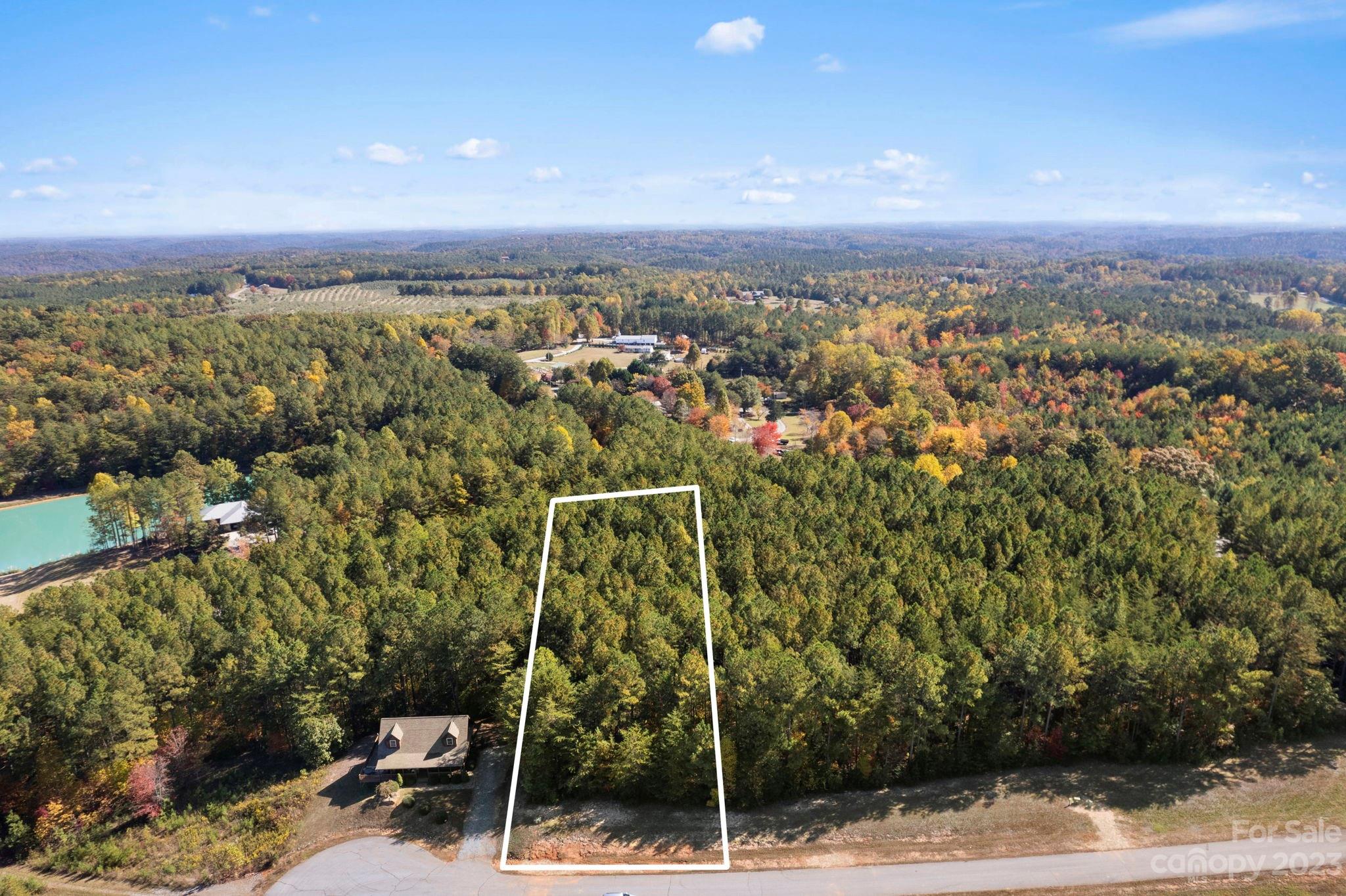 Come build your dream home on this flat, buildable lot just minutes to Lake Lure! You will enjoy the serenity and of feeling like you're a world away, but not far from the conveniences that you need. Short-term rentals are allowed within the community, so you can build a vacation home for you and rent it out when you are not enjoying it yourself. This lot is 1.20 acres and priced below tax value. Come home to Mill Spring! Additional building lots and home available.  Please contact agent for more details.