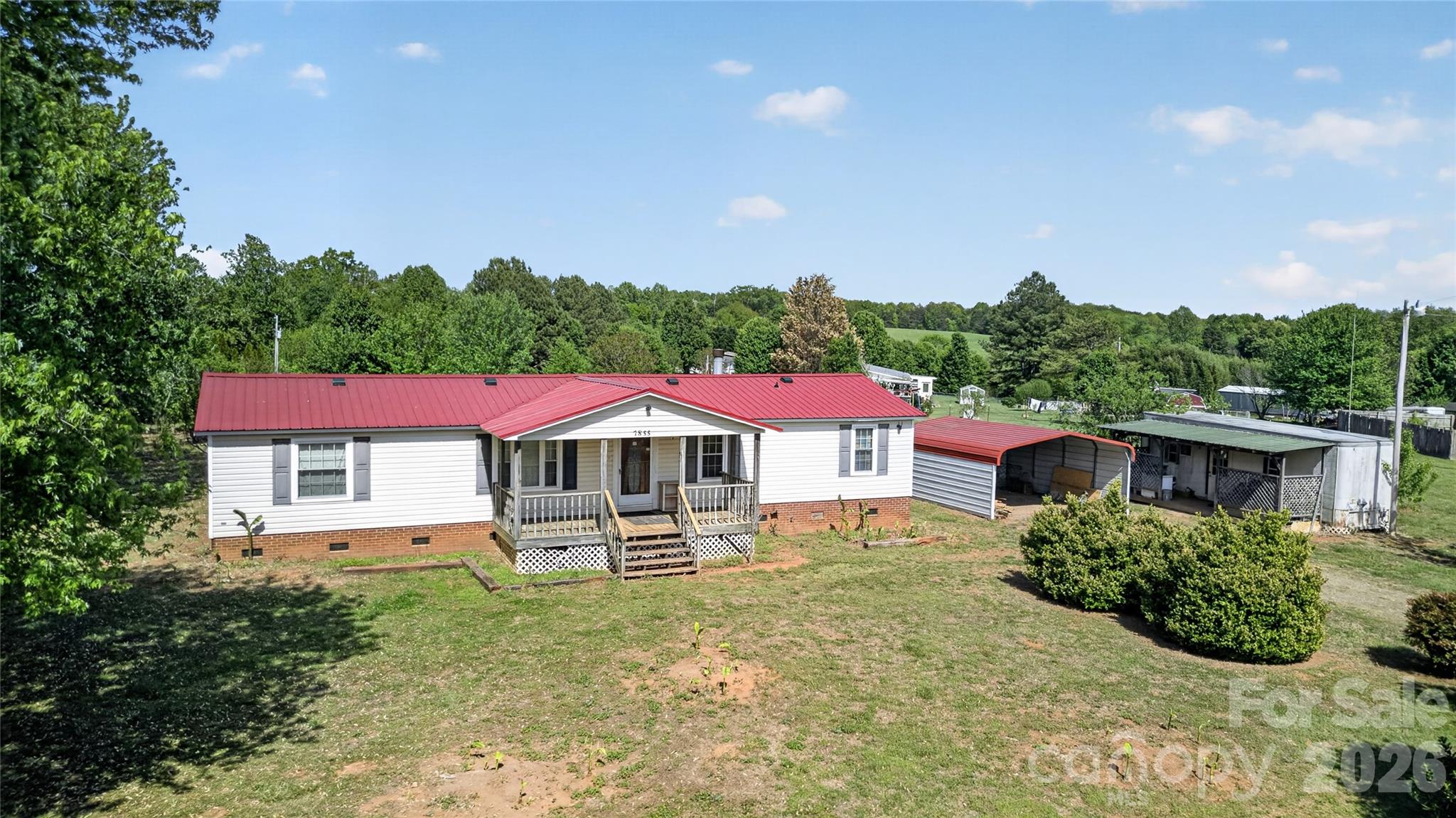 Looking for land and convenience? This manufactured home sits on a generous 1.6-acre lot and offers 1,320 sq ft of living space. Built in 1997, the home features a functional layout and a large carport for covered parking and added versatility. Enjoy peaceful surroundings with plenty of room for outdoor living, hobbies, or expansion. Great opportunity to make it your own!
