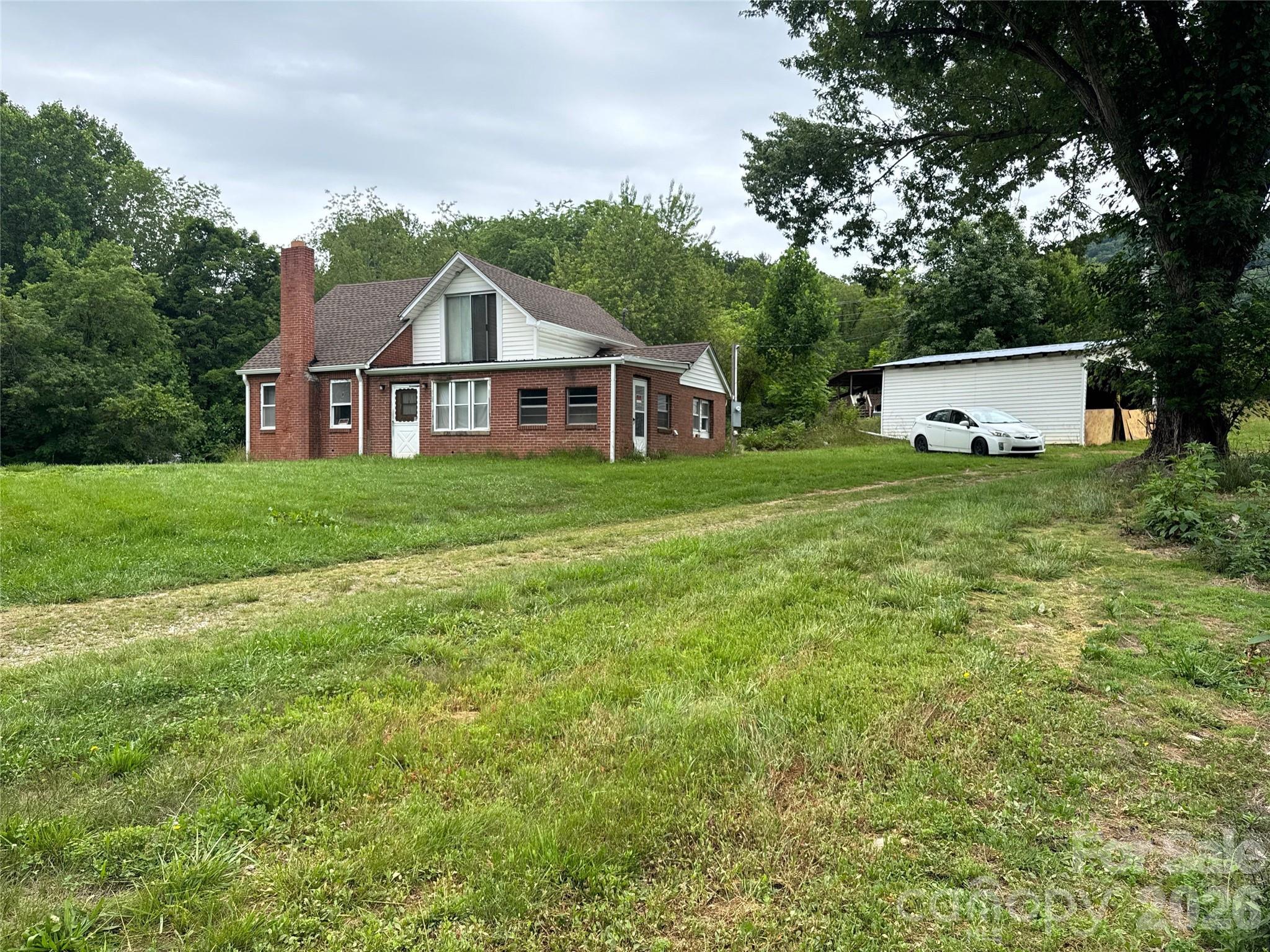 ATTENTION INVESTORS, BUILDERS, & FLIPPERS! Are you looking for your next project in the booming Western North Carolina market? Look no further! Welcome to 102 Ransom Road in Clyde, NC—the ultimate blank canvas with incredible upside potential, just waiting for your vision to bring it to life.
This is a true, top-to-bottom rehab project for anyone looking to build immediate equity. The existing structure features a classic 3-bedroom, 1-bathroom layout, but the interior is fully primed to be gutted, reconfigured, and customized to your exact specifications. Want to open up the floor plan, add a second bath, or design a high-end modern farmhouse? You have the ultimate freedom here. Please note: The property is being sold strictly AS-IS. There is currently no electricity or heat source in the home, making it a perfect candidate for a cash purchase.
Spread out over 1.28 beautiful acres of mountain-breeze land, this property offers way more than just a house flip. The expansive lot size offers the exciting possibility of being subdivided to add an additional homesite! (Buyer will need to confirm specifics and obtain approval with Haywood County). Imagine flipping the main home and building a new spec home or selling off the extra lot. Additionally, a rustic barn sits on the property, providing excellent bones for tool storage during renovations, a workshop, or a fantastic design feature to integrate into your final landscape plans.
Location is everything, and this property hits the sweet spot. Tucked away in a peaceful Clyde setting, you are perfectly positioned for commuter convenience. You are just minutes away from Waynesville for shopping, dining, and local breweries, with quick, easy highway access making commutes to Candler or downtown Asheville a breeze.
 Schedule your showing today and map out your next venture!