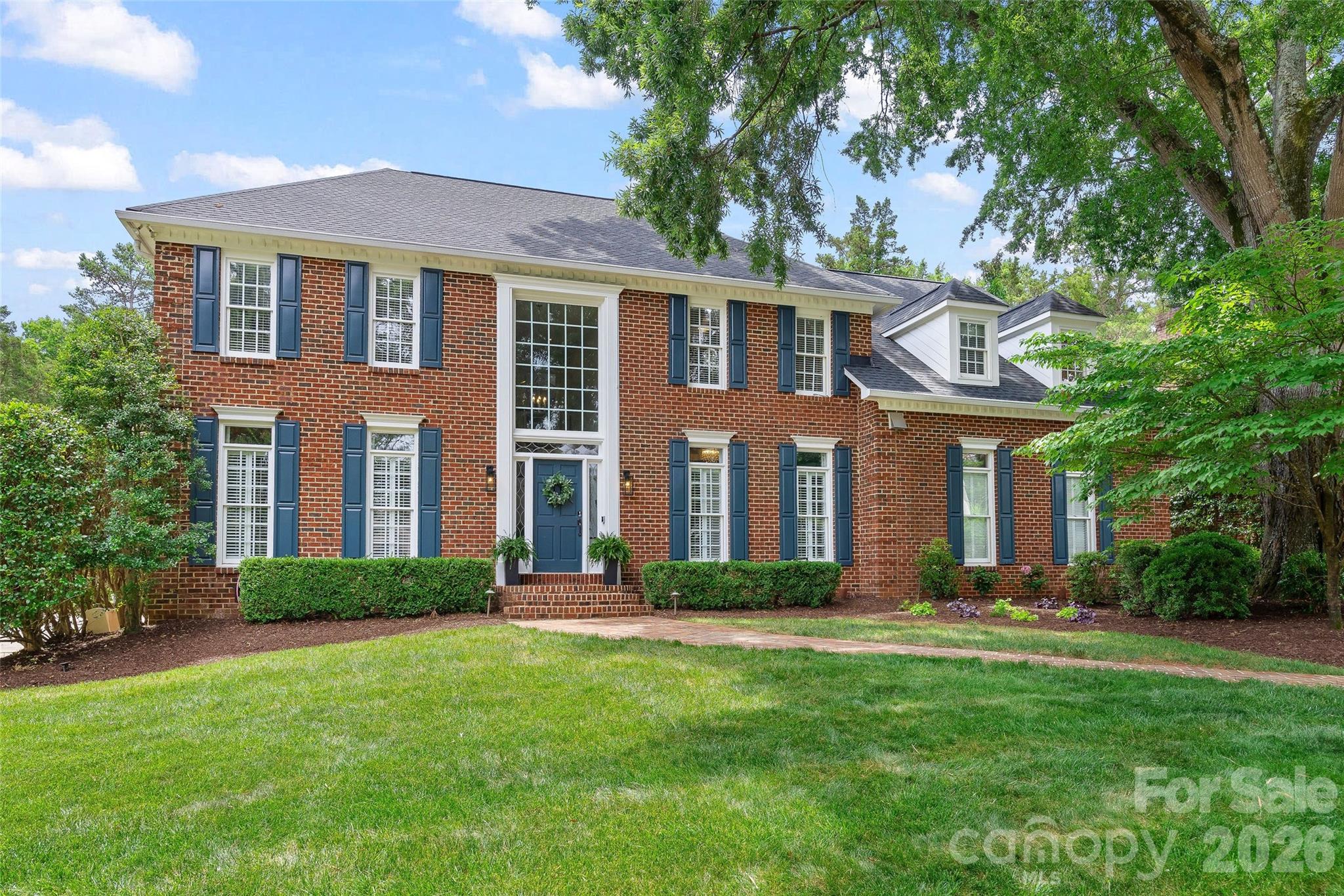 Timeless architecture, exceptional craftsmanship, and resort-style outdoor living define this beautifully renovated residence in the coveted Windswept community. Nestled on a private, professionally landscaped .44-acre homesite, this exceptional full-brick home offers more than 4,000 square feet of thoughtfully designed living space with four bedrooms, three-and-a-half baths, an oversized bonus room or fifth bedroom, and a three-car side-load garage. Located in one of South Charlotte's most desirable established neighborhoods, Windswept is an intimate enclave of just 75 custom homes surrounded by mature trees, offering a peaceful setting just minutes from SouthPark, Uptown Charlotte, premier private schools, shopping, dining, and recreation.

From the moment you enter the dramatic two-story foyer, the home's quality and attention to detail are immediately evident. Extensive millwork, heavy moldings, elegant front and rear staircases, and beautifully proportioned living spaces create an atmosphere of timeless sophistication.

At the heart of the home is a beautifully renovated chef's kitchen designed for both everyday living and memorable gatherings. Custom white cabinetry, granite countertops, a large center island with bar seating, decorative glass tile backsplash, premium JennAir 48” gas range with double ovens, exterior-vented hood, beverage refrigerator, abundant storage, and generous prep space combine beauty with exceptional functionality. The adjoining family room features custom built-ins surrounding a gas fireplace and is filled with natural light, while the adjacent sunroom with its soaring cathedral ceiling opens through French doors to one of the home's most spectacular features.

The backyard is a true private retreat. Designed for year-round enjoyment, the heated saltwater gunite pool and spa feature elegant waterfall spillovers, expansive travertine decking, and a full brick privacy wall that creates an exceptionally peaceful outdoor oasis. Whether hosting summer gatherings or enjoying a quiet evening by the pool, this outdoor living space rivals that of a private resort. Professionally designed landscape lighting, irrigation, and beautifully maintained grounds complete the experience, while the pool pump, filter, and salt cell were all replaced in 2025.

The primary suite offers a luxurious escape with a tray ceiling, oversized custom walk-in closet, additional secondary closets, and a beautifully renovated spa-inspired bath featuring granite countertops, rich wood cabinetry, a jetted soaking tub, and an oversized glass-enclosed shower. Three additional bedrooms and two fully renovated secondary bathrooms provide exceptional comfort for family and guests, while the expansive bonus room with hardwood flooring and closet offers endless flexibility as a media room, home office, playroom, or fifth bedroom. A walk-up third-floor attic provides abundant storage rarely found in today's homes.

Every room in the home has been thoughtfully updated, blending timeless design with modern comfort. Significant improvements include hardwood flooring, a new architectural roof in 2022, tankless water heater, extensive interior renovations throughout, and numerous additional upgrades that allow the next owner to move in and immediately enjoy.

Rarely does a home offer this combination of timeless architecture, comprehensive renovations, exceptional craftsmanship, resort-style outdoor living, and one of South Charlotte's most desirable locations. This is luxury living at its finest—designed for elegant entertaining, comfortable everyday living, and making memories for years to come.