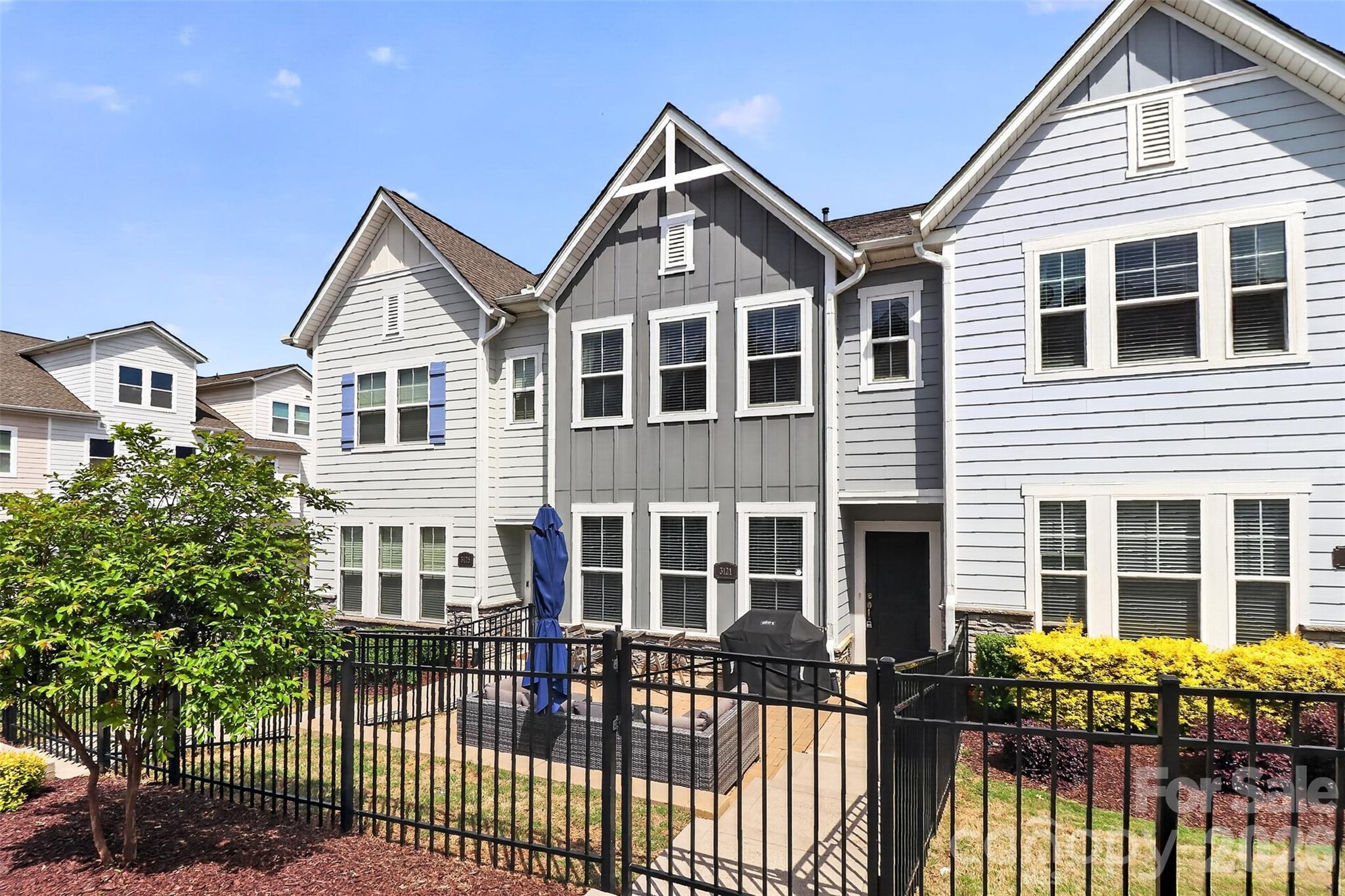 Welcome to 3121 Ada Mill Alley! Tucked between NoDa and Plaza Midwood, and just steps from local favorites like Summit Coffee, Humbug, Grey's Diner, Rhino Market, Free Range Brewing, and the Greenway. This is Villa Heights living at its best. What sets this home apart is the third level. Up here is a private flex room with its own full bath, completely separate from the rest of the home. Use it as a dedicated work-from-home sanctuary, a media room, a guest space, or whatever your life calls for. It's a versatile space that most homes simply don't offer, plus a walk-in attic for extra storage. Step inside and you're immediately on the main living level, no stairs to climb before you're home. The open kitchen, dining, and living area flows seamlessly together. The chef's kitchen features a gas cooktop, hood vent, wall oven, white cabinetry, sleek tile backsplash, farmhouse sink, and a large island with seating area. A pantry and powder room complete the floor. Upstairs, the oversized primary suite features a tray ceiling, dual vanity, oversized shower with bench seating, and a generous walk-in closet with wood built-ins. Two additional bedrooms, a full bath, and a dedicated laundry room round out this level. The attached two-car garage provides secure parking and ample storage, a true premium in this neighborhood. Additional guest parking is directly in front as well. Built by one of Charlottes highest rated builders, David Weekley Homes, this Sinclair floor plan offers 4 bedrooms, 3.5 bathrooms, and 2,242 square feet across three levels with high-end finishes throughout and it lives far larger than it looks.