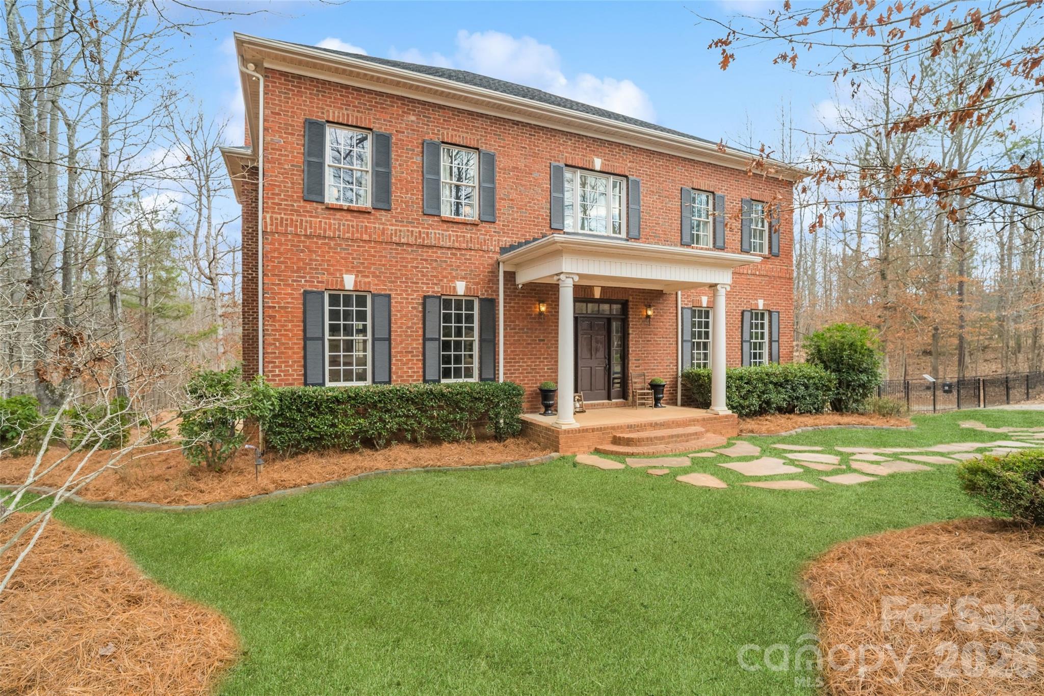 Priced BELOW tax value AND appraised value and set on 8.9 acres!! This full brick home offers the privacy of a country oasis with timeless appeal. The yard was thoughtfully designed by a landscape architect, and the sellers have the original drawings available. Enjoy the outdoors with four-wheeler trails cut throughout the property, complete with a creek crossing and scenic hiking trails. Refrigerator, washer and dryer stay, and furniture is also negotiable if buyers prefer! With beautiful hardwood floors throughout, 10’ main-level ceilings, and 9’ ceilings upstairs, this one is a must-see. A dedicated office with built-in shelves provides the perfect work-from-home setup, and fiber internet through Spectrum is available. The spacious kitchen features double ovens, new stainless steel appliances from 2024, butler's pantry, ample cabinet space, beadboard backsplash, and gas cooktop. The extra large laundry room impresses with a sink, folding station, and storage cabinets. The primary suite offers a true retreat with double walk-in closets, tiled walk-in shower, soaking tub, and separate vanities. A Jack-and-Jill bath adds convenience between two secondary bedrooms. Outdoor living shines with a covered deck featuring gas connections for a grill/outdoor kitchen, plus a covered patio off the partially finished walkout basement, offering endless potential for expansion or recreation. Basement includes a finished bedroom, several unfinished areas just needing drywall, and a concrete tornado enclosure with built-in food storage racks. Take advantage of the concrete pad ideal for an RV or secondary patio. Additional highlights include a central vacuum system, 3-car garage, new septic pump (2024), and newer roof (2022). Irrigation system is installed but needs repair. Horses are welcome!! Recent appraisal available upon request.