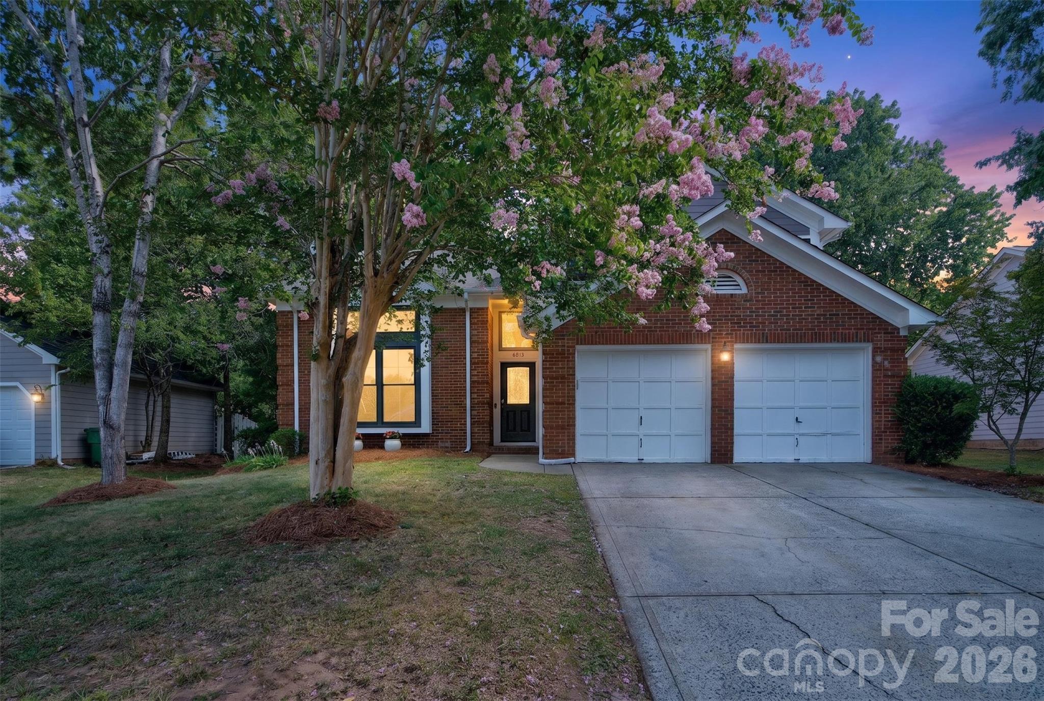 Tucked beneath mature trees in the desirable Landen Glen community, this move-in ready home has been thoughtfully updated by professional master craftsmen and is a true showstopper from the moment you arrive, boasting a stunning renovated kitchen and spa-inspired bathrooms throughout.
Step inside to a soaring two-story living room bathed in natural light, where brand new luxury vinyl plank flooring spans the main level and upstairs and fresh interior paint sets an inviting tone. The dining room flows just off the entry, distinguished by elegant millwork and a dramatic tray ceiling, before opening into the beautifully renovated kitchen. Built for everyday living and entertaining alike, the kitchen features neutral white quartz countertops, striking navy and white cabinetry, dimensional subway pillow tile that extends all the way to the ceiling, stainless appliances including a 5-burner gas range with griddle, and a generous center island. A sun-filled breakfast area with a bay window alcove links the kitchen to the cozy family room, where a wood-burning, floor-to-ceiling brick fireplace with hearth and new expansive sliding glass doors frame views of the backyard and create an easy indoor-outdoor flow. Rounding out the main level are a convenient half bath, laundry room, extra storage, and access to the attached two-car garage, complete with a storage room featuring shelving, a built-in workbench, and its own entry door. Upstairs, the spacious primary suite offers a private retreat with a jaw-dropping, spa-inspired bath, complete with a freestanding soaking tub, frameless tiled shower, dual-sink vanity, skylight, and walk-in closet. Three additional bedrooms share a beautifully remodeled hall bath finished with a stylish freestanding vanity and porcelain tiled tub surround. Vytex Fortis replacement windows throughout the home deliver both energy efficiency and style, while the fully fenced backyard invites relaxation and entertaining with its expansive deck, fire pit, storage shed, and the cool shade of mature trees. Ideally located near the shopping, dining, and entertainment of Blakeney, Rea Farms, and Waverly, this exceptional home blends timeless style with everyday comfort. Don’t miss your opportunity to make it yours.