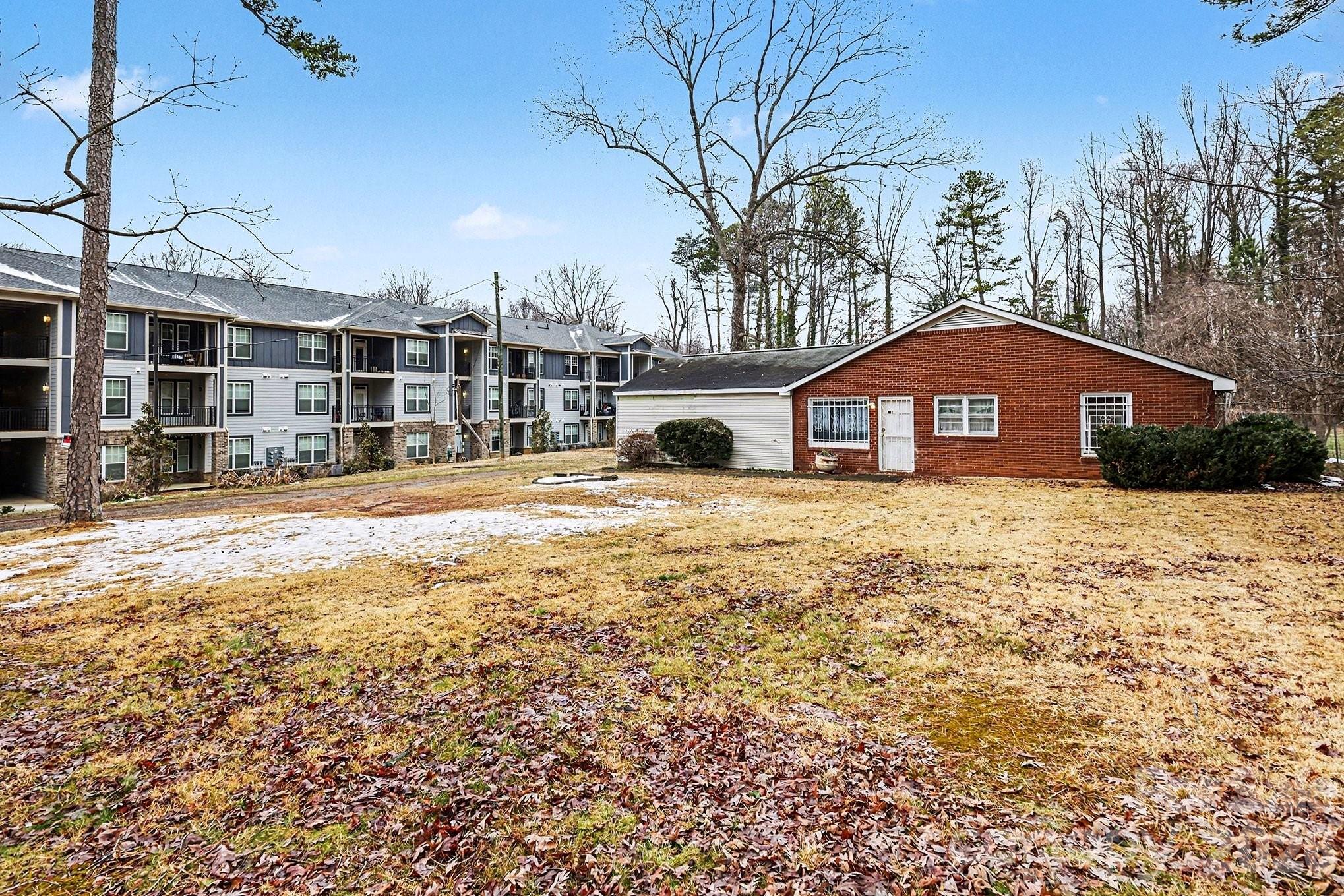 One of the last available lots on Tom Hunter Rd!   This .69 acre lot offers plenty of room for development or for your own private homeplace.   Located in an up and coming part of Charlotte, you are minutes away from shopping, restaurants, banks and everything else that you need.  The house is a large structure that could be transformed into almost anything with some great imagination and creativity!