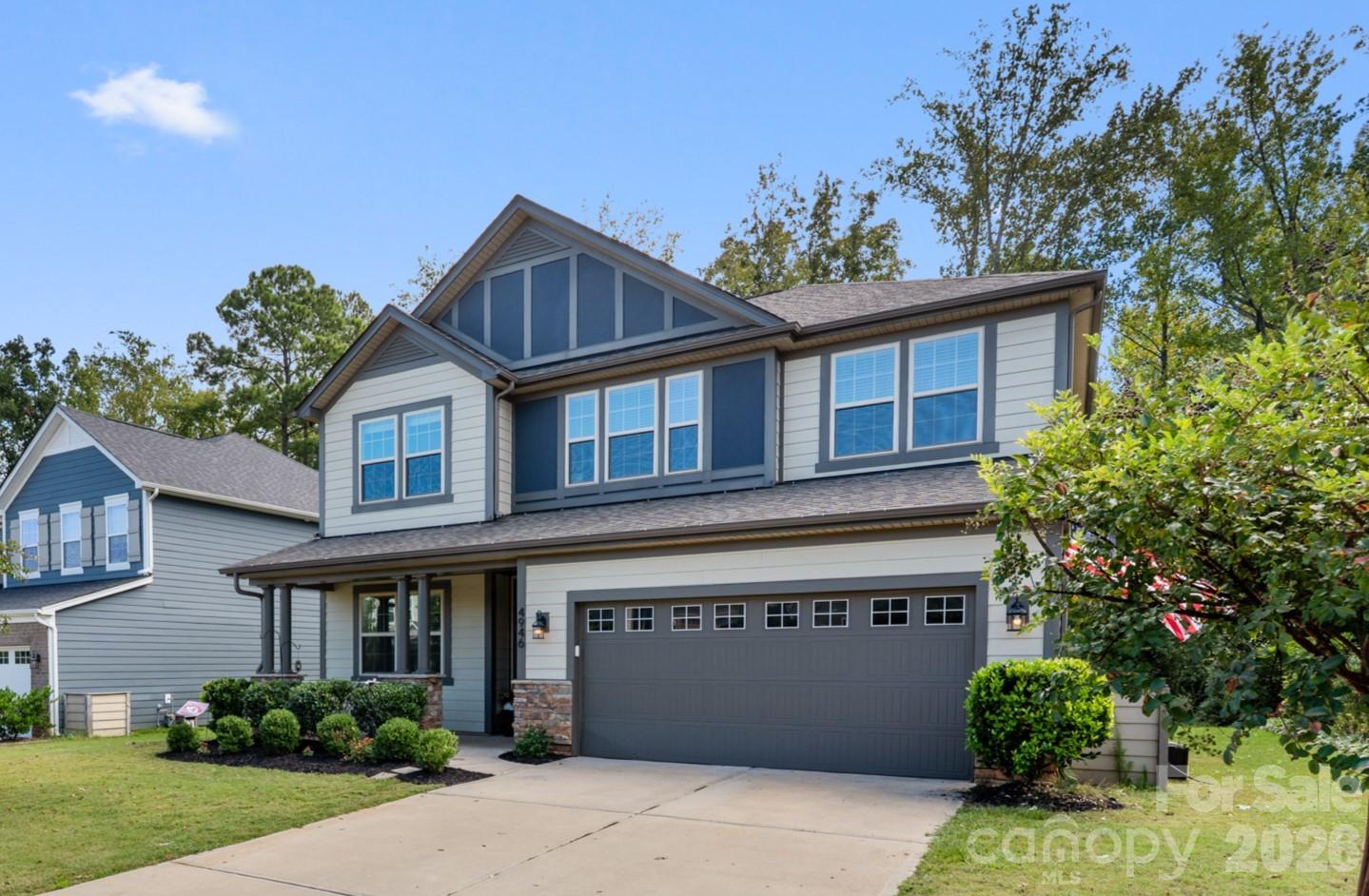 Tucked against a private nature preserve on a premium lot, just steps from the pool and playground, this 4BR, 2.5BA, 3,114 sq. ft. home in the Lake Crest community of Lake Wylie offers the perfect blend of privacy, space, and convenience. Enjoy wooded views and direct trail access from the backyard, ideal for morning walks, playtime, or unwinding at the end of the day.

Inside, the open main level features 9’ ceilings, 8’ doors, and a layout designed for both everyday living and entertaining. The kitchen includes granite countertops, a large island, stainless steel appliances, gas cooktop with vented hood, wall oven/microwave, reverse osmosis system, and a walk-in pantry, all opening to a spacious living area anchored by a gas fireplace with custom shiplap and built-ins. The main level also includes a dedicated drop zone and flexible space for a home office or study.

Upstairs, the loft offers versatile living space for a playroom, media room, or second family room, along with three additional bedrooms. The primary suite features two walk-in closets and a spa-style bath with dual vanities, soaking tub, and walk-in shower, creating a private retreat separate from the secondary bedrooms.

The tandem garage provides space for a third vehicle, golf cart, home gym, or additional storage. The backyard offers both privacy and usable space, making it ideal for entertaining, relaxing, or enjoying the natural surroundings.

Located in a desirable community with easy access to Lake Wylie, shopping, and dining, and zoned for highly sought-after Clover schools with low South Carolina taxes, this home combines location, layout, and lifestyle in one, a place that truly feels tucked away while still being close to everything.  Welcome Home to the Carolina Blue sky.