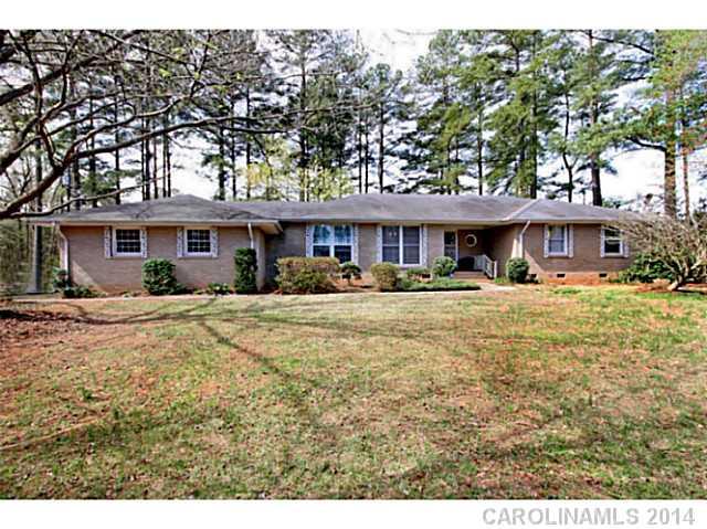 Handy Man Special!! Full brick ranch home with 2 car garage on over 2 acres in desirable Huntersville location with Cabarrus county taxes! 1.25 acres of the 2.12 can be divided up to 2 lots and resold as a buildable lots or build a couple homes! Home features large great room, living room with wood burning fireplace, dining room and good size kitchen! Relax on the deck overlooking flat yard and trees! Storage building and 1 year home warranty included! Plus, no HOA!