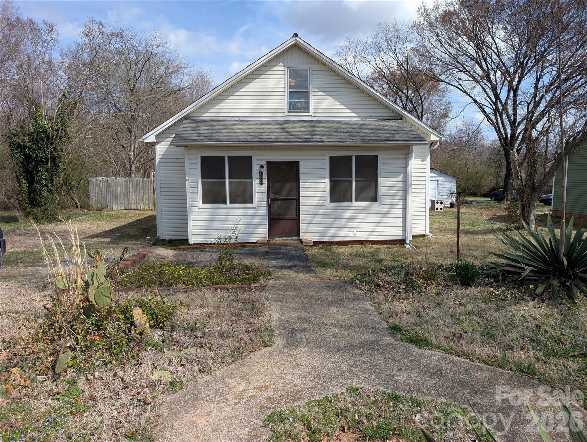 Charming 2 bed, 2 bath Mill House built in 1923, only minutes from Downtown Troutman and convenient to I-77 and I-40. Enter into the enclosed front porch with a sunroom vibe, a cozy living room opens to a large eat-in kitchen and beyond that a dining/den area overlooking the covered back porch. Two bedrooms, one with original beadboard ceiling, double closet, and window seat with storage; the other with an ensuite bath and a unique bonus room/loft space accessible by a pull-down attic staircase. Property has been a reliable rental for the last 14 years while only having two tenants in that time. It is well maintained, clean and move in ready. Large and flat lot allows for plenty of space to enjoy the outdoors, entertaining or gardening. Small water pond could be beautiful once again with minimal effort. Extra large shed building has concrete floor and electricity making it perfect for projects or storage, and an additional smaller shed with dirt floor for lawn equipment and garden tools. This home has stood the test of time and is ready for another chapter. Bring your personal touches and add to its story!