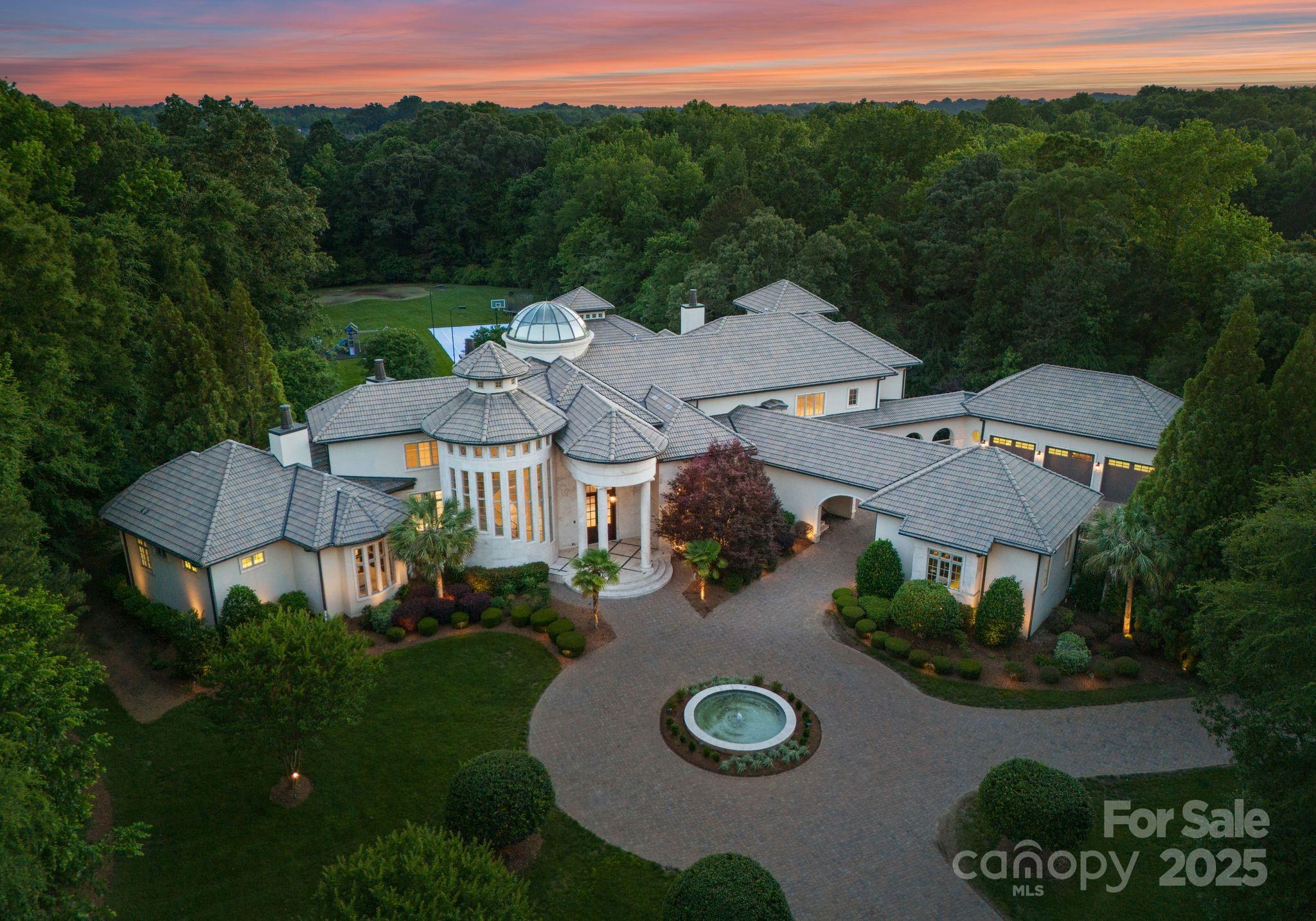 "LIVE LIKE A CHAMPION" in this truly One Of One Legacy Estate where luxury, privacy and prestige meet. This 12,000 SF estate on 5-acres offers unrivaled privacy, luxury, and scale. Owned by NBA legend and all-star, this home features soaring 30-ft ceiling in the living room, elevator, exquisite architectural details and grand living spaces. Designed for both entertaining and relaxation, amenities include a regulation lighted basketball court, professional gym with sauna and steam room, home theater, full bar with billiards and 8-car garage. The chef’s kitchen flows into elegant living areas, while the expansive primary suite offers a spa-like retreat. Outdoors, enjoy rolling lawns, private pond, pool and hot tub with cabana, wooded seclusion and multiple outdoor gathering spaces. A gated drive ensures total privacy. Built by and for someone who lives life at the highest level, this estate is a legacy property—rare, refined, and unforgettable.  Don't miss your opportunity to live like a champion!
