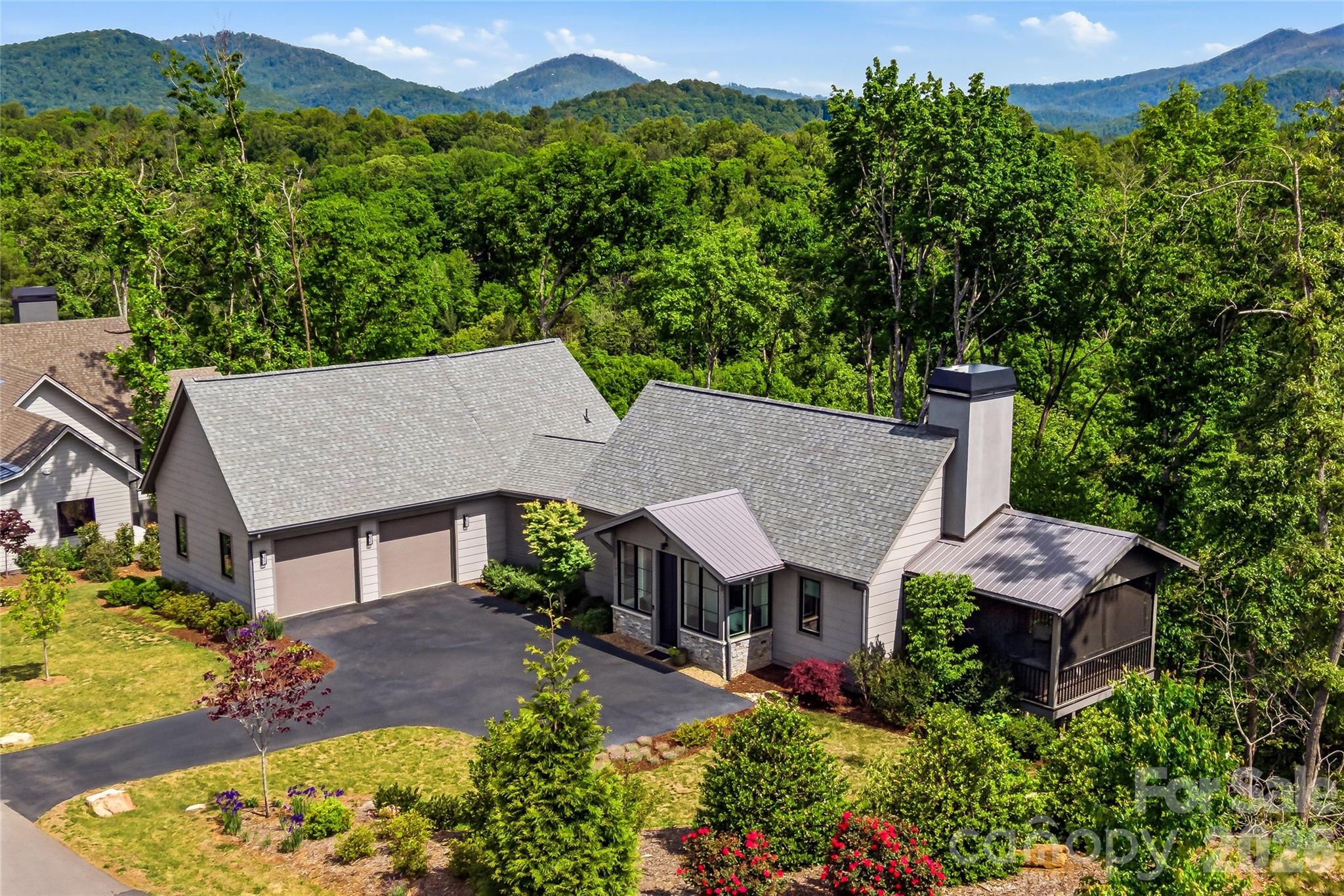 Set within the quiet, gated enclave of Riverbend Forest, 162 Riverbend Forest Drive embodies the understated elegance and natural beauty synonymous with refined Asheville living. Just moments from downtown, this residence offers river and mountain views with effortless access to the area’s celebrated dining, culture, and outdoor pursuits.

A light-filled, open-concept design unfolds with gracious living spaces tailored for both intimate moments and sophisticated entertaining. The kitchen serves as a true centerpiece—appointed with abundant custom cabinetry, sleek surfaces, and mountain views—seamlessly connecting to the living and dining areas for an elevated yet inviting experience.

The primary suite is a serene retreat, complemented by well-proportioned guest rooms and flexible spaces suited for work or leisure. Outdoor living areas invite quiet mornings and relaxed evenings, surrounded by the tranquility of the natural landscape.

An exceptional offering where privacy, design, and location converge—capturing the essence of timeless mountain luxury