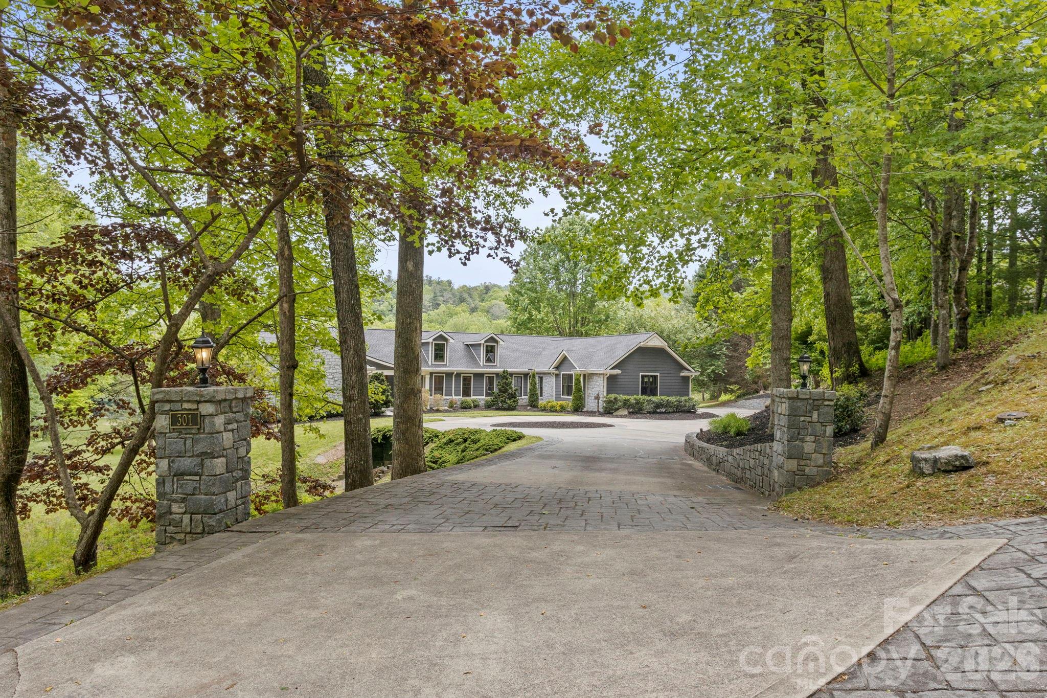 Experience extraordinary luxury living in prestigious Kenmure- a gated golf course community in this absolutely stunning, fully renovated masterpiece overlooking the 18th fairway. Perfectly positioned on a premier 0.87 acre mostly level lot with a stream bordering the property, this exceptional open concept 3 bedroom, 3.5 bath home offers the utmost privacy, breathtaking golf course views and exquisite designer finishes throughout. No detail was overlooked in this complete transformation creating a like-new luxury residence of unparalleled quality and sophistication. Prepare to be impressed from the moment you arrive via the stately circular driveway and elegant entrance. The expansive main level features over 3,000 square feet of refined luxury living with all new hardwood and designer tile flooring, all new windows and doors, stunning designer lighting fixtures and exceptional architectural detailing throughout. The inviting great room showcases a soaring cathedral tongue-and-groove ceiling with beam, expansive windows framing the picturesque setting and a spectacular gas fireplace with old-world brick surround flanked by custom cabinetry. A stylish bar area with wine cooler, granite countertop and glass display cabinetry creates the perfect setting for entertaining. The elegant dining area flows seamlessly into the spectacular designer kitchen featuring gorgeous shaker cabinetry, unique hardware, stunning granite countertops, designer tile backsplash, oversized farmhouse sink, walk-in pantry, built-in recipe bookshelves and high-end Thermador appliances including an oversized gas range with custom curved artisan wood hood, built-in microwave with sensor cooking, 36 inch refrigerator/freezer and dishwasher, abundant cabinetry and drawer space. The spacious breakfast area completes this incredible gathering space designed for both entertaining and everyday living. The luxurious primary suite is a true retreat featuring access to the private deck, custom walk-in closet with built-ins and an extraordinary spa-inspired bath with dual granite vanities, freestanding soaking tub, oversized tiled shower with bench and glass enclosure and separate water closet. Additional main level highlights include a spacious study or guest bedroom with deck access, a beautifully appointed guest suite with exquisite bath boasting designer tile floors, double vanity and walk-in tiled shower, elegant powder room, huge walk-in coat closet, and oversized laundry room with washer and dryer, sink, cabinetry with plenty counter space and built-in ironing board. The stairway leading to the lower level is absolutely stunning with exquisite detailing on walls and gorgeous designer tile on the landing that lead to the beautifully finished lower level offering an ideal guest or in-law suite complete with a full-size kitchen featuring stainless appliances and granite countertops, expansive family and recreation rooms, large bedroom, full bath with granite vanity and tub/shower combo, bonus/craft room, flex space, and tremendous storage areas. Outdoor living is equally exceptional with expansive decking and patio areas overlooking the pristine green space, stream, and spectacular 18th fairway setting. Additional highlights include two brand new HVAC systems, new water heater and a prime location just a short stroll to the clubhouse and outstanding amenities of Kenmure. This is an extremely rare opportunity to own a completely renovated luxury home on one of the most desirable lots in the community. Exceptional craftsmanship, exquisite taste and timeless elegance define this magnificent residence.
