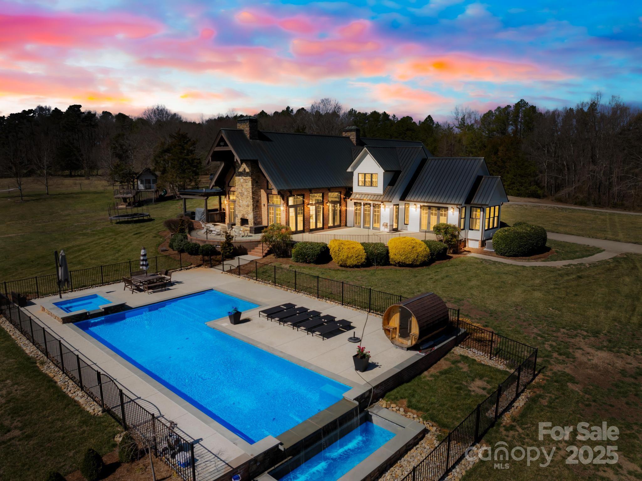 This stunning 141-acre property boasts breathtaking views and features a beautifully designed lodge with floor-to-ceiling windows. The architecture is inspired by nature, offering a perfect blend of luxury and comfort. Inside, the upgraded kitchen includes a walk-in pantry, ideal for gourmet cooking. A greenhouse adds to the property's charm, along with an impressive 11-stall horse barn for equestrian enthusiasts. The outdoor space is truly remarkable, with a spa-like pool, sauna, and even a treehouse, making this estate a private sanctuary with endless luxury amenities.

Seller is also offering 25 acres of this land plus the house for 3,000,000.00. Please refer to mls number 4254770 for property details.