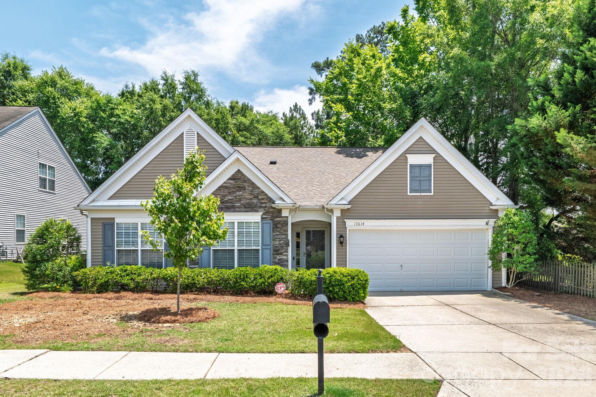Nestled on a quiet, tree-lined homesite in sought-after Highland Creek, this well-maintained ranch offers effortless one-level living with an open, inviting floorplan designed for everyday comfort and entertaining. The spacious living room flows seamlessly into the kitchen featuring white cabinetry, center island, breakfast bar, pantry, and abundant prep space. Along with the breakfast area, the dining room provides additional entertainment space. The primary bedroom features a tray ceiling, walk-in closet, and ensuite bath with dual vanity, complemented by two additional bedrooms and a full guest bath. Enjoy peaceful mornings or relaxing evenings in the rear screened porch overlooking a wooded backdrop that enhances privacy. 2-car attached garage. Residents enjoy access to Highland Creek's extensive amenities including clubhouse, tennis and pickleball courts, playground, walking trails, recreation area, all conveniently located near shopping, dining, I-485, I-77, and Uptown Charlotte.