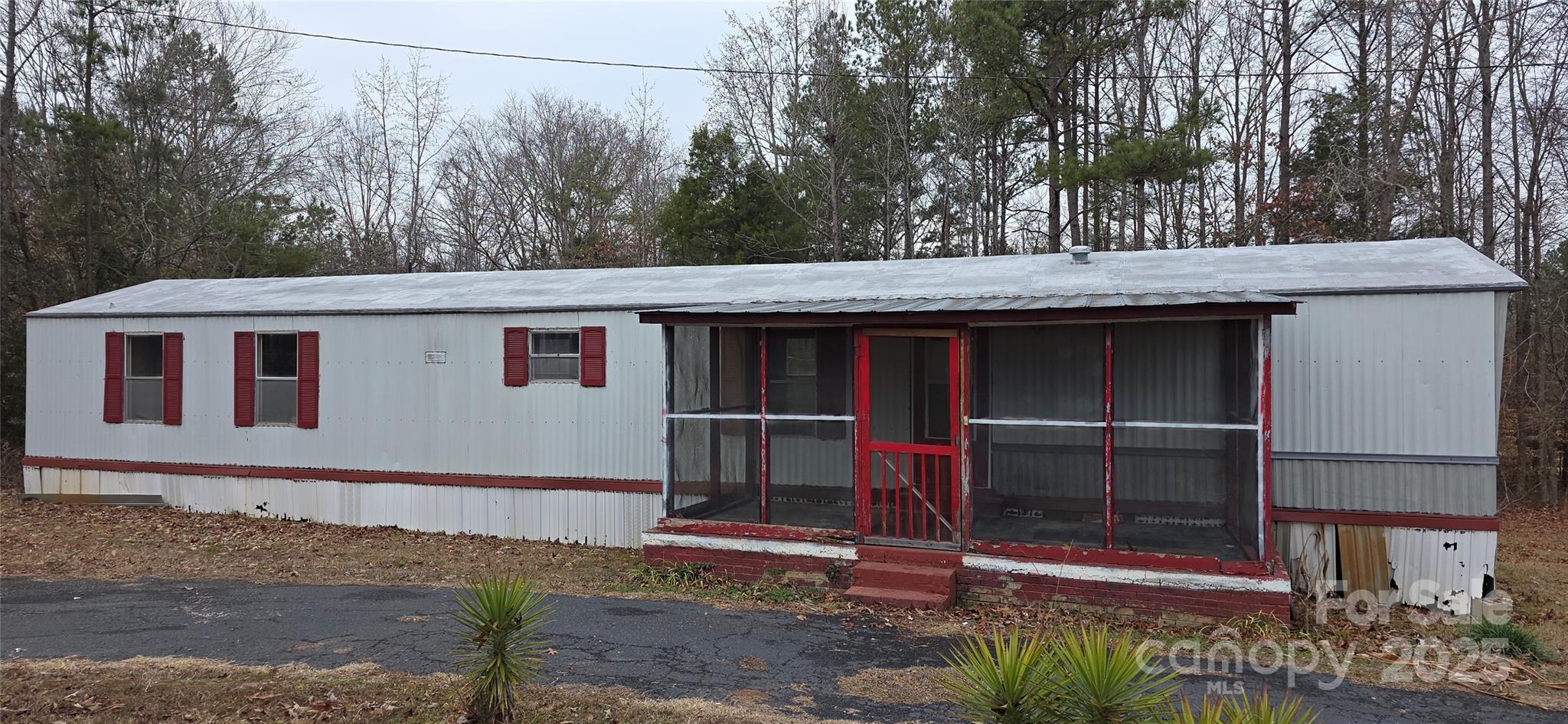 Priced for quick sale/motivated Seller - Situated on a highly sought-after one-acre, level lot, this affordable 2 bedroom, 2 full bath home has been freshly cleaned and is ready for its next chapter. Whether you’re looking to downsize, purchase your first home, or transition from renting to owning, this property offers incredible potential. With a little TLC, the possibilities truly shine through or take advantage of what's happening with all of the surrounding New Construction and start fresh with a brand-new build. Entertain with ease and dream big! The expansive one-acre lot provides plenty of parking and space for everything from backyard cookouts and graduation celebrations to unforgettable family gatherings, or even a beautiful outdoor wedding. Once Under Contract, you can start planning your next celebration right away! Perfectly positioned near restaurants, shopping, medical facilities, the hospital, and University of Southern Carolina Lancaster, this home also offers convenient access to Hwy 521 and I-77, making daily commutes and weekend adventures a breeze. Opportunity, location, and potential all come together here, don’t miss your chance to make it yours!