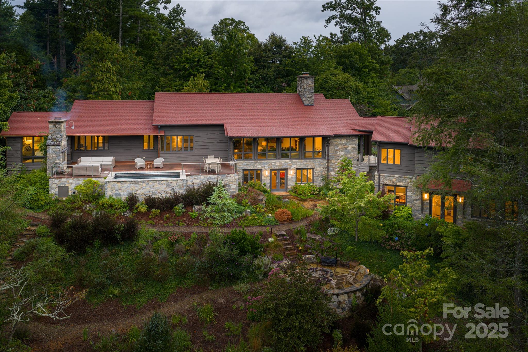 A masterclass in clean lines, open spaces, and modern design, where every detail reflects intentional simplicity. Walls of glass frame sweeping mountain vistas, blurring the line between indoors and out. Ideally situated in the heart of the iconic Grove Park neighborhood, yet secluded on a private acre, this home offers the best of the Asheville living.