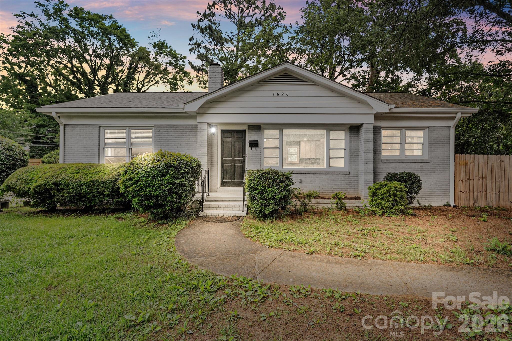 Welcome to this beautifully updated ranch home offering the perfect blend of modern finishes, functional living space, and an unbeatable location just minutes from Uptown Charlotte, Camp North End, and NoDa. This move-in-ready 3-bedroom, 2-bath home features an open-concept floor plan designed for today's lifestyle. Inside, you'll find vinyl plank flooring, recessed lighting throughout and a spacious living room anchored by a charming fireplace that creates a warm and inviting focal point. The kitchen is both stylish and functional, featuring granite countertops, stainless steel appliances, abundant cabinetry, and seamless flow into the main living areas, perfect for entertaining guests or everyday living. Both bathrooms have been thoughtfully updated with modern finishes, while the dedicated mudroom/laundry room adds convenience and valuable storage space. Situated on a rare double lot, the outdoor space is equally impressive as the home. The fully fenced backyard offers room for pets, play, gardening, entertaining, or future possibilities, while mature trees provide privacy and character. A storage shed offers additional flexibility for tools, hobbies, or outdoor equipment. Additional highlights include a newer HVAC system, updated lighting, modern fixtures, and the ease of single-level living. Whether you're a first-time homebuyer looking to build equity or simply seeking a move-in-ready home close to Charlotte's most exciting destinations, this property offers an exceptional opportunity. Enjoy easy access to breweries, restaurants, entertainment, and employment centers while benefiting from the space, flexibility, and freedom of no HOA.