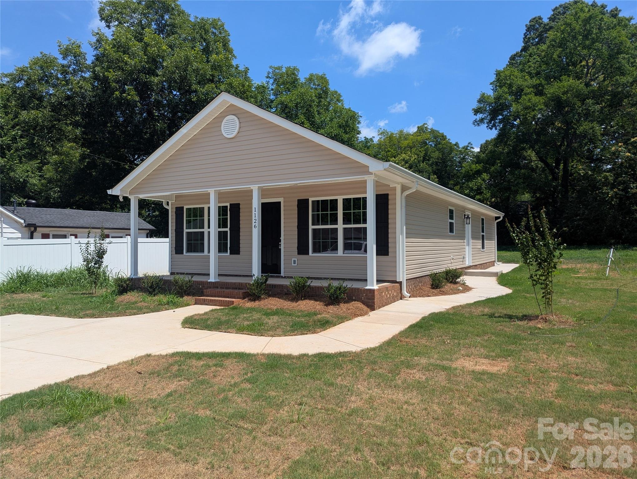 Welcome home to a favorite Rock Hill floor plan! Move-in ready with construction just completed July 2026. Walk into open living and dining, as well as the full kitchen. The kitchen features an island, and ample cabinet storage appropriate for the space. The refrigerator, stove, dishwasher, and microwave are included. Down the hall, bedroom two, the first of the nicely sized guest bedrooms is on the left, followed by the full guest bathroom with a single vanity and a shower/tub combination. The first right of the hallway is a functional path to the side entry of this home. The laundry room with W/D hook-ups, a fully enclosed pantry for added storage, and a coat closet complete the space. Bedroom three follows on the right side of the hall just before the primary. The primary is quite spacious making up the back of the house with a deep walk-in closet and a private en-suite bathroom. This bathroom also features a shower/tub combination and a larger single vanity. Enjoy granite counters and LVT flooring throughout the house, no carpet. Central heat and A/C, and everything is electric! This plan has a concrete walk path extending from the driveway to both the side entry and a rear patio.