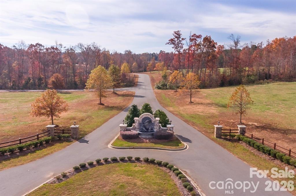 ELEGANT custom-built ESTATE w/exceptional attention to detail! McNeely Farms is an upscale, equestrian-friendly community featuring large custom homes on 3 to 5+ acre lots. Located near Mineral Springs, this neighborhood offers a tranquil setting w/wooded terrain and access to the local greenway directly across from the neighborhoods main entrance. Nestled in the back left corner of the neighborhood, this private sanctuary sits on 3+ acres & also features a charming 2-bedroom guest cottage which provides plenty of room inside & out for family & guests. The main home presents with an expansive circular driveway & 4-car garage providing abundant parking. Be prepared to be impressed as you approach the front entrance! You are welcomed by substantial custom double metal doors giving a taste of what to expect next!

Inside, you will be captivated by the home’s remarkable architectural details, including antique brick from the 1880's gracing the fireplace, intricate ceiling ornamentation, beautiful wide-plank hardwood floors, imported tile, & so much more.

Enjoy seamless indoor-outdoor living w/a serene covered terrace featuring TREX flooring, wiring for speakers & television, accordion sliding doors opening from the main living area invite in the surrounding natural beauty.

The chef’s kitchen is truly exceptional, featuring top-of-the-line Wolf appliances including double wall ovens w/ convection cooking & thermometer probe, gas cooktop, refrigerator drawers, & a built-in Sub-Zero freezer. Additional highlights include beautiful custom cabinetry (some w/unique rain glass fronts), a hidden appliance cabinet, pantry w/motion-sensor lighting & space for two refrigerators or freezers, dual garbage pullouts. Expansive center island w/stunning walnut countertop and an oversized custom extended galley sink with dual faucets and reverse osmosis tap. Kitchen also features an additional standard size galley sink. The fireplace adds the perfect finishing touch.

The luxurious main-level Primary Suite features his-and-her closets. The custom-designed "her" primary closet includes built-in shelving & drawers, pull-out necklace trees, upper third-row pull-down rods w/soft-close functionality for easy access. The spa-inspired bath offers a large deep soaking copper tub, leather-finished granite countertops, custom cabinetry & an amazing walk-through shower w/built-in speakers. Additional features include wiring for a TV in front of the tub, specialty tile, outlets inside cabinets for convenient and discret charging stations & a free form custom vanity.

Additional highlights include:
• Area designated for a future elevator
• Drop zone with hooks crafted from antique railroad ties
• Entire home wired for surround sound and security system including cameras
• Marine-grade outdoor water connections
• Well with NEW pump, NEW motherboard, filtration system, and water softening system
• Revani water system in the primary bath
• Central vacuum systems in the primary bath, kitchen, laundry room, and bar area, each with 21 feet of range

The lower level features a spacious family room, game area, space designated for a safe room (also ideal for a wine room), expansive gym with custom rubber flooring, media room, bar, playroom (wired for a golf simulator), three bedrooms & two full baths with custom tile—one featuring tile imported from Italy & the other from Spain—plus a storage/mechanical closet.

••Closet near the garage entry can easily be reconfigured to a staircase leading to the MASSIVE unfinished attic, offering the opportunity to expand the finished living area or provide exceptional additional storage.

For Horse lovers, McNeely Farms Equestrian Center is a stones throw away & offers full service horse boarding & dressage training facility. This property truly HAS IT ALL! Meticulously built and beautifully maintained, this ONE-OF-A-KIND ESTATE offers luxury, privacy & exceptional craftsmanship throughout.