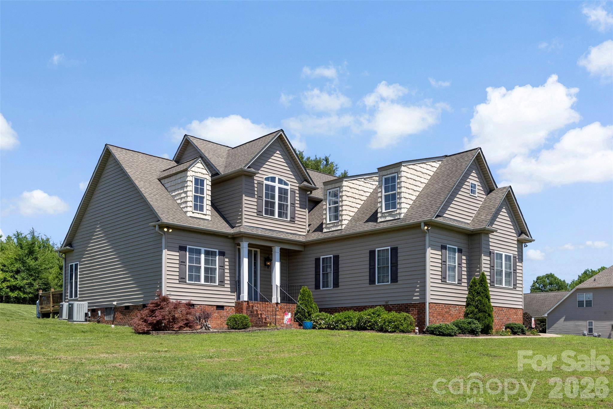 Welcome to 816 Springs Rd.  This beautiful home offers upper-end finishes from the time you step up to the front covered porch & beautiful front door w/sidelights. Inside, you will find a spacious foyer and a formal dining room w/picture frame molding & a unique trey ceiling. Moving on to the soaring two-story great room & stone fireplace with hearth & gas logs. Open kitchen with an abundance of custom cabinets with custom pull-outs & pantry area. Center Island with sink & bar plus designated breakfast area. Half bath with a custom vanity perfect for guests. Large Primary Bedroom on main with trey ceiling & room for a sitting area. Primary bath with 2 separate vanity areas, whirlpool tub, shower & water closet. Laundry room on main complete with cabinets. Open stairway leads upstairs to 2 additional bedrooms, each with a unique ceiling, a shared full bathroom & huge bonus room with lots of storage areas. Large Deck area in back overlooks open backyard, perfect for entertaining & grilling. Propane tank services gas logs & grill connection.  Conveniently located just minutes off 321 on a beautiful street overlooking rolling farm land. All of this and an oversized garage to top it all off!