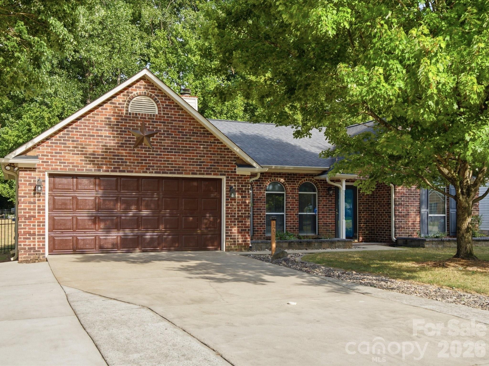 Welcome to 127 W Bank Drive, where thoughtful updates, privacy, and outdoor living come together in one exceptional property. This all-brick, 3-bedroom, 2-bath home is tucked away on a quiet cul-de-sac with no HOA and no current development plans behind the property thanks to the adjacent greenway.

Inside, you'll find durable laminate flooring throughout, a stylish dining room featuring a beautiful stone accent wall, and a functional laundry room complete with custom cabinetry, tile backsplash, and a butcher block countertop. The spacious primary and guest closets have been enhanced with closet systems, providing excellent storage and organization.

Step outside to your private backyard retreat, designed for entertaining and relaxing. Enjoy evenings around the firepit, or gather under the 12x12 metal-roof pavilion. The fully fenced backyard also includes raised garden beds and backs to a peaceful greenway, offering added privacy and a natural setting.

Additional highlights include an extra-wide driveway, a 10x10 storage room with custom shelving, wired surround sound (AC receiver needed), a new stove (2026), and a nearby community pool available with a membership.

This move-in ready home offers the perfect combination of comfort, functionality, and outdoor living in a highly desirable location.