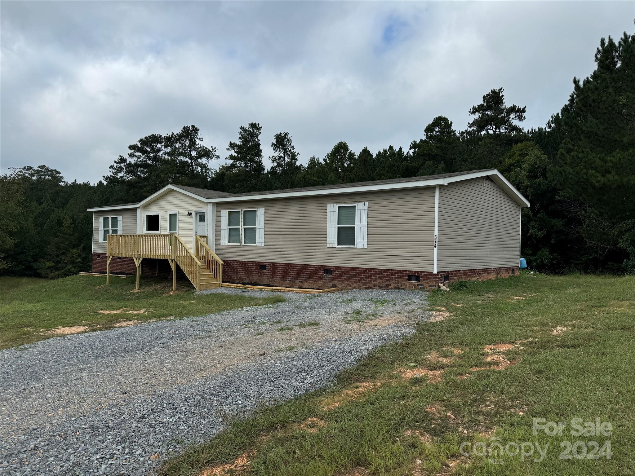 Approximately 2026 Sq Ft 4 Bedroom 2 Full Bath Manufactured Home. Large Kitchen with Large Work Counter, New Range, New Refrigerator, Dishwasher. and Pantry. Dining Area, Den, Living Room, Laundry Room, Main Bedroom/Bath with Walk in Closet, His and Hers Vanity, Garden Tub and Separate Shower. Central Heat and Air, Private Well and Septic, 1.52 Acre Lot, Permanent Foundation.