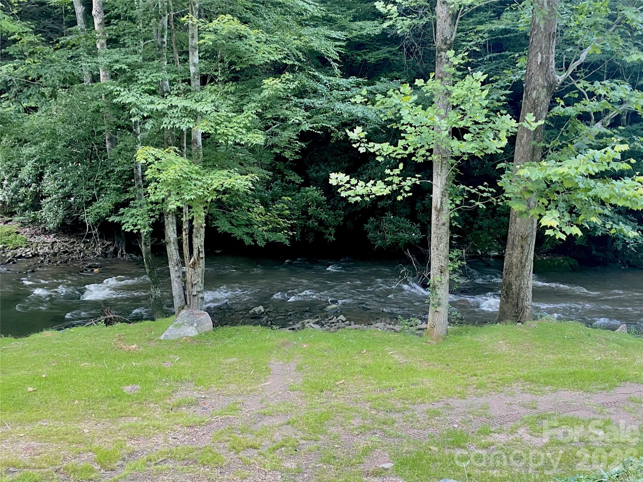 Beautiful 14.87± unrestricted acres in Marshall, NC featuring approximately 860 feet of Big Laurel Creek frontage. This unique property offers a private and peaceful setting with endless possibilities for recreation, investment, or future development. Sellers recently created an easy pull-down access area ideal for RV parking, creek access, or creating your own private beach area along the water.

Enjoy excellent hunting, trout fishing, and outdoor recreation right from your property. Potential ridge-top homesite offers the opportunity for mountain views with selective clearing. Unrestricted land allows flexibility for a cabin, vacation retreat, camping, or full-time residence. Conveniently located while still offering the privacy and natural beauty of Western North Carolina.