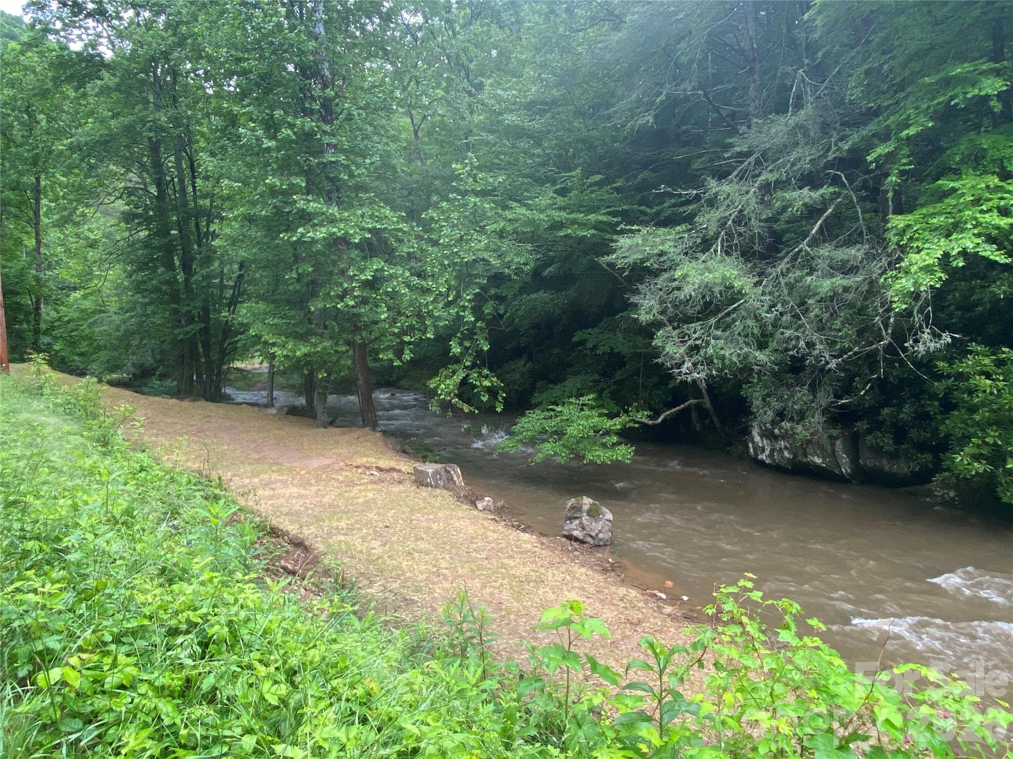 Beautiful 14.87± unrestricted acres in Marshall, NC featuring approximately 860 feet of Big Laurel Creek frontage. This unique property offers a private and peaceful setting with endless possibilities for recreation, investment, or future development. Sellers recently created an easy pull-down access area ideal for RV parking, creek access, or creating your own private beach area along the water.

Enjoy excellent hunting, trout fishing, and outdoor recreation right from your property. Potential ridge-top homesite offers the opportunity for mountain views with selective clearing. Unrestricted land allows flexibility for a cabin, vacation retreat, camping, or full-time residence. Conveniently located while still offering the privacy and natural beauty of Western North Carolina.