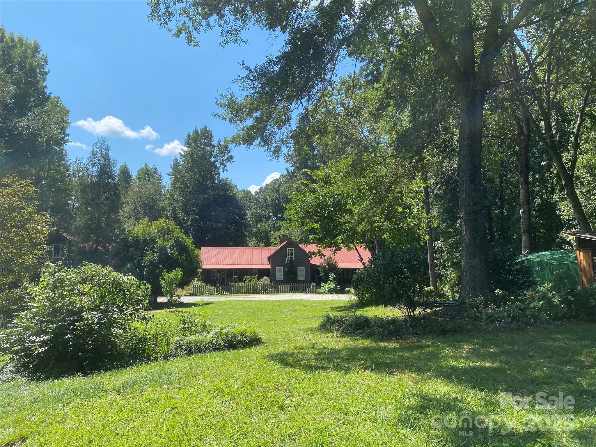 TRULY SPECIAL turn-of-the-century farmhouse with multiple additions that honor the original structure! Charm, history  & modern conveniences, all on 15 private acres suitable for horses, agriculture or family retreat. Located directly on the GENTS Equestrian trail system. Solid wood throughout, no drywall - this construction is the real thing, not decorative shiplap. Acreage includes an established grass pasture near the house, over 5 acres of flat bottom land borders the Middle Tyger River, plus wooded areas that ensure total privacy. Metal roofs, extensive porches and decks, fenced back yard, chicken coop, the answer to all your dreams. Move in ready - most of the living space is new build designed to reflect the original farm house structure. Plenty of space behind the 3 car garage for a livestock run-in or build stalls under the overhang, add the horse fencing and you are ready to go! Perfect homestead property for growing your own food - currently in agricultural status.