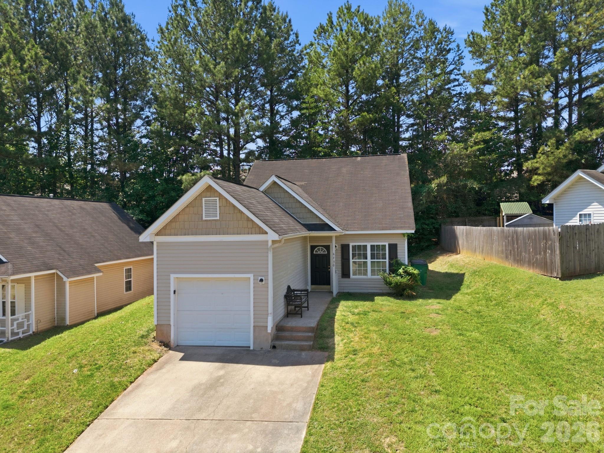 Ideally located less than 15 minutes from the heart of Charlotte and just 10 minutes from University of North Carolina at Charlotte, this beautifully updated 3-bedroom, 2-bathroom home offers comfort, convenience, and fresh updates throughout! Recent improvements include brand new flooring, fresh interior paint, and new kitchen appliances including a refrigerator and range, creating a move-in ready space with a modern feel. Inside, you'll find tons of natural light and an inviting layout highlighted by vaulted ceilings in both the living room and primary bedroom, adding openness and character to the home. The spacious primary suite provides a relaxing retreat, while two additional bedrooms offer flexibility for guests, a home office, or additional living space. Enjoy outdoor relaxation on the side patio, perfect for morning coffee or unwinding in the evenings. A one-car garage adds everyday convenience and extra storage.