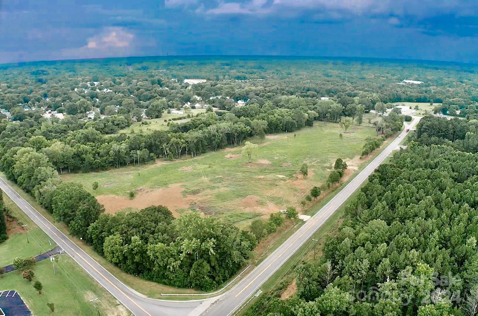 This land offers so much! Making this your perfect farm or business with a beautiful home site on top of the hill overlooking the entire farm, mostly pasture, some nice big hardwoods, and a peaceful creek along the back east side of the property line. This parcel is not in the city limits and zoned ID-1 for industrial use, providing 4000+ ft of combined road frontage. The rich soil would provide a beautiful tree farm/nursery. Electric, natural gas, city water, city sewer and fiber internet available. Sits on the corner/intersection of Lowrys Hwy (Hwy 321) & Pickney Rd (Hwy9) (directly across from Dollar General) as well as Dawson Road and Back Gate Street. Located less than 30 minutes from York and Rock Hill. (ID-1 Chester County uses available from agent)