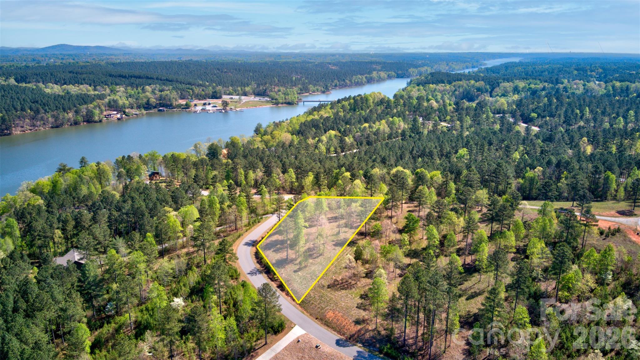 Build your dream home on this 1.34-acre corner lot in the gated Island Pointe at Lake Vistas, where Lake Rhodhiss and the Blue Ridge Mountains create a breathtaking backdrop. This build-ready homesite is elevated for privacy and features long-range views of Table Rock and seasonal lake views. The property was previously perked for a three-bedroom home and is bushhogged annually for easy viewing. Enjoy premium community amenities including a private boat ramp, picnic area, and underground utilities. Located just minutes from Castle Bridge public access and an hour from Charlotte, Asheville, and Blowing Rock, this lot offers the perfect mix of mountain-lake seclusion and city convenience. Whether for a primary residence or a vacation retreat, this property is the ideal setting for your North Carolina escape.