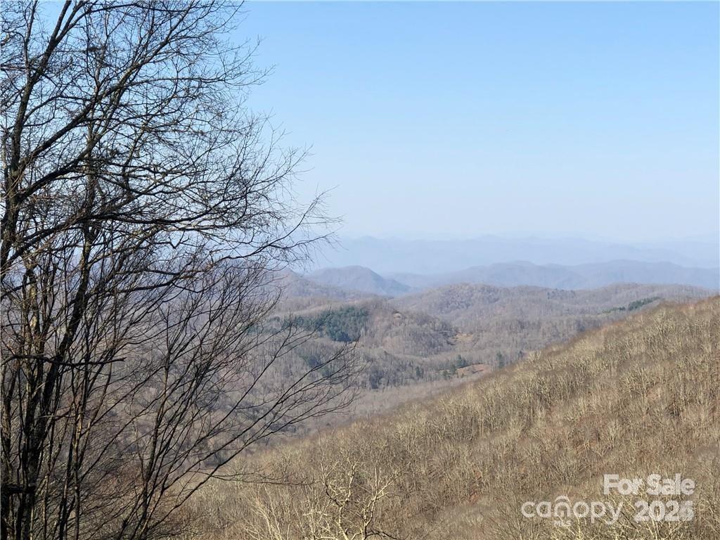 Amazing lot with high elevation and southern exposure with long range views in gated community. Septic permit information attached to listing. Close access to golf course, fitness center, hiking, pickleball, tennis courts and newly updated Hatley Pointe ski slopes and recreation area. Come enjoy cool summers above 4500ft elevation and passive southern exposure. ONE OF THE BEST SPOTS IN WOLF LAUREL COMMUNITY!! Brokers must be with buyers to show property and get through gated security. Village amenities and WL country club must have memberships to participate, fees reflected in listing do not reflect the fees.