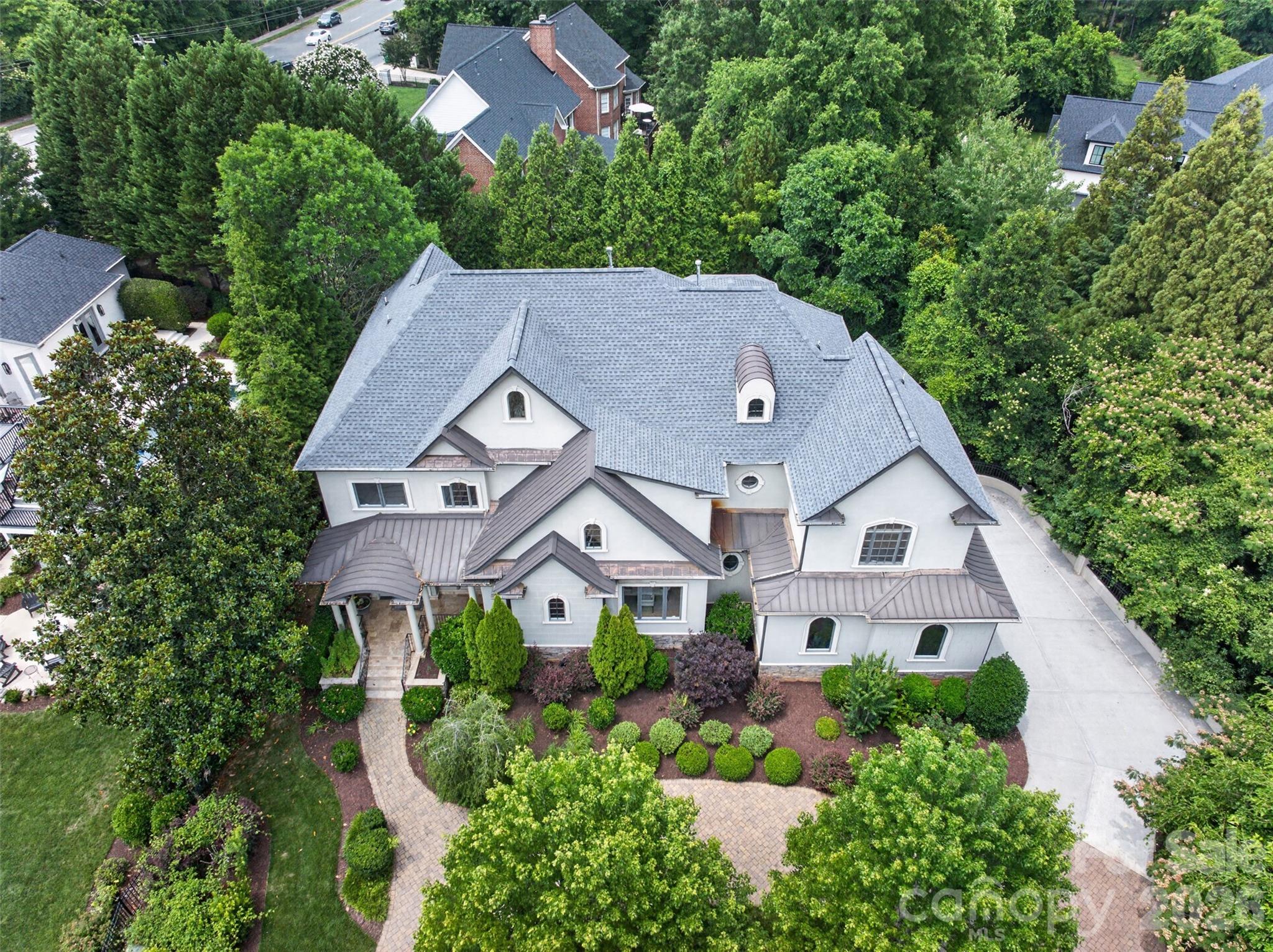 Exceptional custom home in the heart of Foxcroft offering 7,701 square feet of thoughtfully designed living space across three levels. A grand entry welcomes you into elegant formal and casual living areas, including a formal dining room, spacious family room, and gourmet kitchen with breakfast nook overlooking the beautifully landscaped backyard. The main level also features a private guest suite with a full bath, perfect for visitors or multigenerational living. Upstairs, retreat to the luxurious primary suite complete with a gas fireplace, private deck, spa-inspired bath with soaking tub and custom-tiled shower, and generous closet space. An open loft with wet bar creates the perfect gathering area, while additional bedrooms each feature their own private baths.
The expansive lower level is designed for entertaining and everyday enjoyment, featuring a full kitchen, theater room, multipurpose space, fifth bedroom, and an additional full bath. Outdoor living is equally impressive with a covered deck, covered patio, stunning paver terrace with fireplace, and meticulously manicured landscaping in both the front and rear yards.
Ideally located near SouthPark's premier shopping, dining, and conveniences, this exceptional Foxcroft residence offers luxury living at its finest.