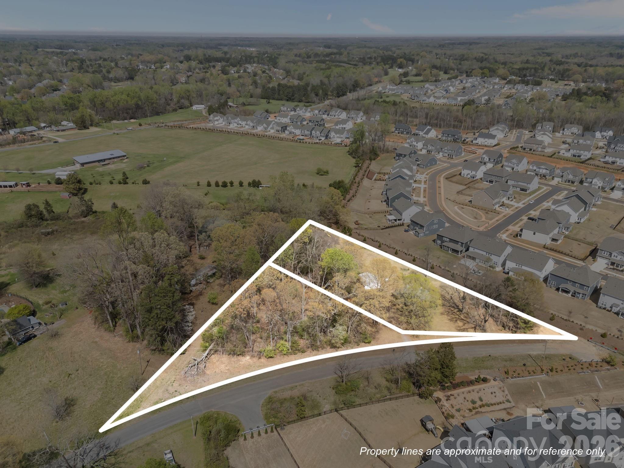 Opportunities like this are few and far between—2.25 acres comprised of two parcels in the heart of Huntersville, offering endless potential for homeowners, investors, and builders alike. Whether you envision restoring the existing home, creating a private estate, or exploring development possibilities, this property delivers flexibility and value in a highly desirable location. Set among large, stately trees, both parcels are relatively flat and offer a beautiful, usable landscape. The larger 1.46-acre parcel features a small brick ranch that has been vacant for approximately two years but could be brought back to life. The home includes 3 bedrooms, 2 bathrooms, a living room, kitchen, and mudroom—ready for renovation or reimagination. A detached two-car garage structure is also on site (though in need of repair) adding additional potential for storage, workshop space, or future improvement.  The adjacent 0.79-acre parcel is fully treed, offering privacy, natural beauty, and additional options. Keep both parcels together for a more expansive homesite or explore selling them separately. There may also be an opportunity to subdivide the combined 2.25 acres into three lots (subject to approval by the Town of Huntersville), making this an attractive prospect for builders or those looking to maximize value. Located in a terrific area close to everything Huntersville has to offer—parks, sports fields, tennis and pickleball courts, recreation facilities, shopping, dining, Lake Norman, and medical care—this property combines space and convenience. Zoned for desirable schools, it’s an ideal setting for a custom home or investment project.  Imagine designing a stunning modern farmhouse, luxury estate, or even multiple homes- creating something truly special in an established and sought-after community.  For sure, this is very unique opportunity to secure land, location, and potential all in one while still being away from traffic of a main road.  Potential to connect to city water/sewer which is just at the corner.  PARADISE CAN EXIST AND YOU JUST MIGHT HAVE FOUND IT