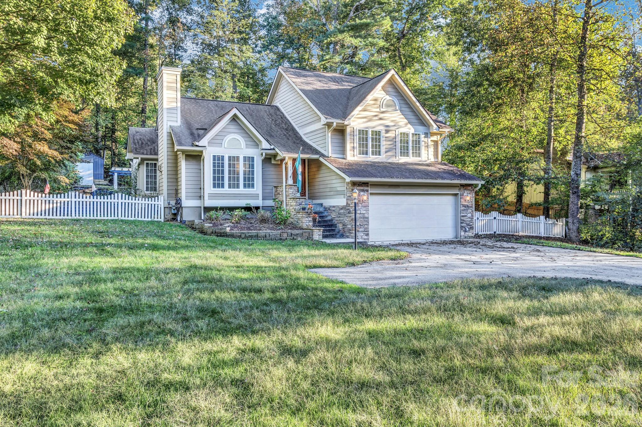 Tucked away in a peaceful South Asheville neighborhood, this beautiful 3-bedroom, 3-bath home invites you to experience the perfect balance of mountain tranquility and modern convenience. With more than 1,400 square feet of open, light-filled living space, every corner of this home feels welcoming, thoughtfully designed, and full of life. From the moment you arrive, you can sense that this is a special place — a home that’s been cared for and loved. The setting offers the best of both worlds: quiet surroundings with easy access to everything you need. You’re just minutes from the regional airport and close to some of Asheville’s best restaurants, shopping, and outdoor adventures. Step outside and discover your own private retreat. A spacious stone patio and deck extend your living space into the open air, framed by a custom pergola and surrounded by lush landscaping. It’s easy to imagine hosting summer barbecues here, laughter echoing around the fire pit, or peaceful evenings under the stars, soaking in the hot tub as the night settles in. Inside, the home is bright and airy, with soaring cathedral ceilings and gleaming hardwood floors that flow throughout the main level. Natural light streams through tall windows, creating a sense of warmth and openness. The custom kitchen is a true centerpiece, featuring granite countertops, rich maple cabinetry, and stainless steel appliances — a place where cooking feels both effortless and inspiring. The main level also offers a cozy family room anchored by a beautiful fireplace — the perfect spot to curl up on cool mountain nights — and a formal dining area that opens easily for gatherings with friends and family. Downstairs, a spacious recreation room with a full bath offers endless flexibility — whether you envision a media room, home gym, guest suite, or creative studio. There’s also generous storage, ensuring every practical need is met with ease. Upstairs, the primary suite feels like a peaceful getaway of its own. Thoughtful design details and a sense of serenity make it the perfect place to start and end each day. Every room in this home has been finished with care, reflecting quality craftsmanship and timeless style. Outside and in, this property is made for connection — to nature, to community, and to the people you love. With upgraded finishes, exceptional outdoor living spaces, and a location that captures the best of South Asheville living, this home offers more than just comfort — it offers a way of life. Come see for yourself why this is one of South Asheville’s hidden gems, and imagine the next chapter of your story unfolding right here.