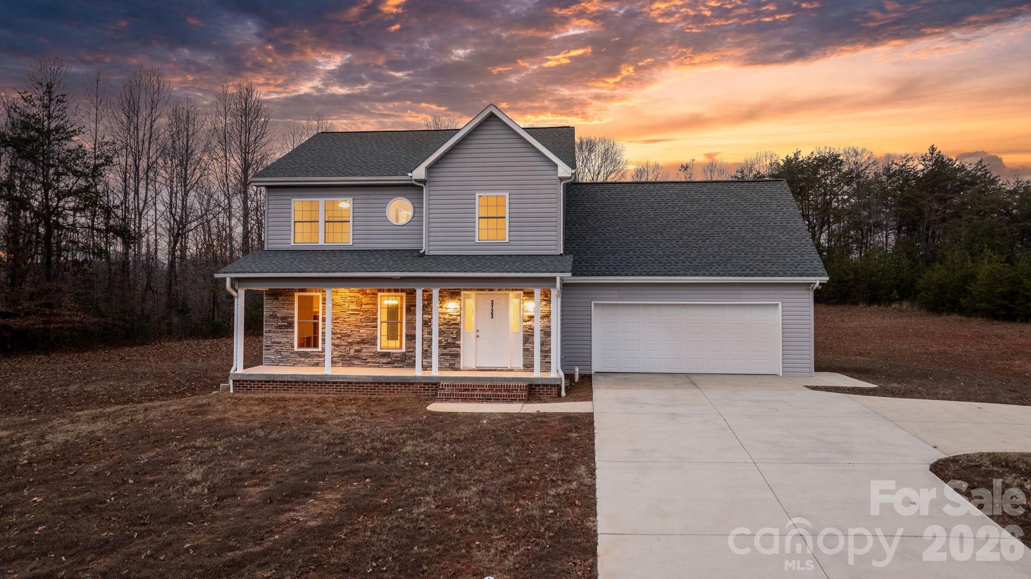 Welcome home to this beautifully crafted move-in-ready two-story residence, perfectly situated on 1+/- peaceful acres at the end of a quiet cul-de-sac. Offering the best of privacy and convenience, this picture-perfect property is surrounded by mature trees and open space—an ideal setting for anyone seeking room to breathe, play, and enjoy nature right outside their door. Even with its serene setting, the home is located just minutes from the shopping, dining, and entertainment options of both Hickory and Newton, and offers easy access to Interstate 40 and Highway 321—making commuting and travel exceptionally convenient.

Step inside to discover a bright and welcoming interior designed with both comfort and style in mind. The spacious living room features warm natural light, a classic brick fireplace, and plenty of room for gatherings or quiet evenings at home. Adjacent you'll find an elegant dining area as well as a charming breakfast nook—each offering serene views of the expansive backyard.

At the heart of the home, the kitchen boasts rich wood cabinetry, ample counter space, and a functional layout ideal for everyday living and entertaining. The appliances shown are virtually staged, and the seller is offering a $2,500 allowance toward kitchen appliances, giving you the freedom to select the perfect finishes to suit your style.

Upstairs, retreat to the inviting primary suite, designed as a peaceful escape from the everyday. The adjoining bathroom features a beautifully tiled surround with stylish hexagon accents and a deep soaking tub, perfect for unwinding after a long day. Large windows frame calming woodland views, creating a serene, spa-like atmosphere right at home.

Outdoors, the property offers endless possibilities—gardening, recreation, pets, or simply relaxing on the wide front porch with your morning coffee. With its long concrete driveway, attached two-car garage, and charming curb appeal, this home is as functional as it is inviting. 

This exceptional property is truly move-in ready and waiting for its next chapter. Whether you're seeking quiet countryside living or a comfortable place to put down roots, this home delivers the perfect blend of space, style, and serenity—all within minutes of Hickory, Newton, and major highways for effortless connectivity.

Don’t miss your chance to make this beautiful home your own—schedule your showing today!