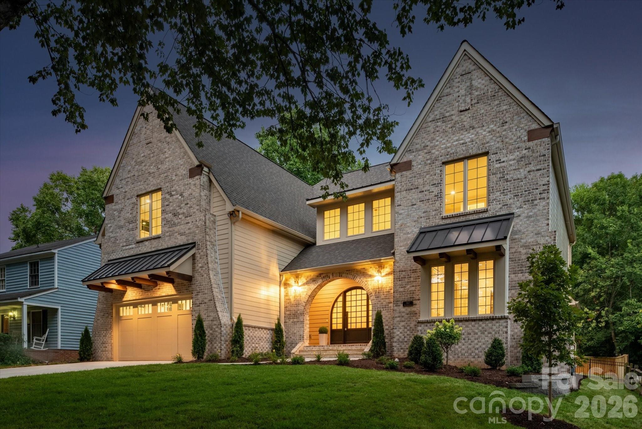 Some of Charlotte's most remarkable homes aren't found on grand boulevards—they're discovered on quiet, tree-lined streets where timeless neighborhoods and exceptional craftsmanship come together. Tucked beneath a canopy of mature trees, this exceptional custom-built home offers over 4,800 square feet with 6 bedrooms, 5 full baths, a luxurious main-level primary suite, and a private study with an adjacent full bath that easily serves as a guest suite. Ideally located just minutes from SouthPark, Park Road Shopping Center, and Uptown Charlotte, this home offers an exceptional blend of luxury, comfort, and convenience. Every finish was selected with purpose, creating a home that feels both timeless and inviting from the moment you walk through the front door. Architectural details—including graceful arched openings, exposed wood beams, curved corners, 5-inch white oak hardwood flooring throughout both levels, built-in bookcases, and extensive custom cabinetry—reflect a level of craftsmanship rarely found in today's new construction. Designed for both everyday living and entertaining, the chef's kitchen features a 48-inch GE Monogram gas range, built-in refrigerator, expansive island, butler's pantry, and a well-equipped scullery. The great room opens seamlessly to the covered outdoor living area, where a tongue-and-groove ceiling and gas fireplace create a natural extension of the home. A second gas fireplace anchors the great room, while extensive custom cabinetry continues throughout the kitchen, scullery, butler's pantry, drop zone, great room, laundry room, and primary suite. The main-level primary suite offers exposed wood beams, custom walnut cabinetry, dual walk-in closets, a spa-inspired bath with soaking tub and oversized shower, plus a convenient stackable washer/dryer location. Upstairs offers four additional bedrooms, a bonus room, and a well-appointed laundry room with custom cabinetry and utility sink. Additional highlights include a 695-square-foot garage, designer tile throughout, CAT6 wiring in the bedrooms, study, great room, and covered porch, surround sound wiring in the great room, kitchen, bonus room, and covered porch, an insulated crawl space with dehumidifier, and a fully fenced backyard with a six-foot privacy fence. Dedicated 50-AMP Circuit for EV Charger (Charger not included). Timeless craftsmanship. Thoughtful design. A home best experienced in person.