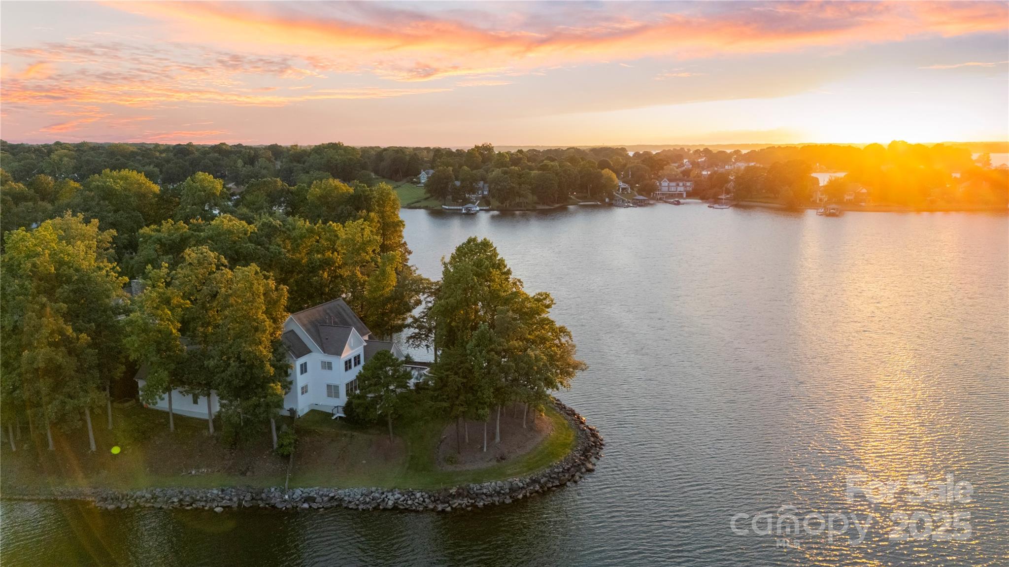 You thought it didn't exist! 440' of shoreline, open water views from sunrise to sunset on private peninsula lot with ES Johnson-built right-sized retreat in a gated neighborhood. Stunning pool & spa steps from the main living area, 3 car garage, primary on the main. Big water views from nearly every room. Open main floor melds living & dining with multiple outdoor entertaining spaces. Kitchen offers oversized island with granite counters, Miele appliances (inc. steam oven), breakfast pantry, and under counter wine fridge. Behind the kitchen is a walk in pantry w/barn door & waterfront laundry room & mud/drop zone. The dining area is surrounded by windows & open to kitchen. Living room has built in bookshelves, gas fireplace, window seat for 2, and sliders leading to covered porch w/vaulted ceiling, gas FP & retractable screens.

The waterfront primary bedroom on main has a covered bluestone patio, an en suite bathroom with garden tub, oversized dual entry shower, split vanities, private water closet, heated towel rack, walk-in closet w/wall safe & windowed flex area for den, or add'l boutique style closet with double glass pocket doors. A silver travertine-wrapped pool & spa (ozone powered, even less chemicals than salt, heated by conventional gas or heat pump) is steps from living area, primary suite & pool bath with shower. Meander upstairs, where the landing features built in bookshelves and a delightful reading area. Two upper bedrooms share a Jack & Jill bath (one of which has access to 317sf of unfinished lake-facing space), and an additional en suite bedroom has 2 walls of windows facing the lake. The rec room has built in desk, wet bar w/under counter fridge & shiplap detailing. 

The 3 car garage, accessed via breezeway, offers 700sf+ of unfinished opportunity, with lakefront windows in place to build out an add'l living space, wellness center, or recreational space. 

This custom home is 9 years young, and offers enhanced rip rap, 2024 tankless hot water heater, security cameras, gutter guards, Hunter Douglas automated shades in living room, security cameras & Control4 technology. On-site kayak/paddleboard launch. *HOA-assigned slip #6 is a short walk from the home & transfers with sale. (Private dock not available in Pointe Regatta per Duke.)*. Truly no wasted space, feels like a yacht; curated and water-oriented.  Located 30 min to Uptown Charlotte & CLT Int'l Airport. Please see attachments for Features Sheet, Floorplan, Survey and add'l info.